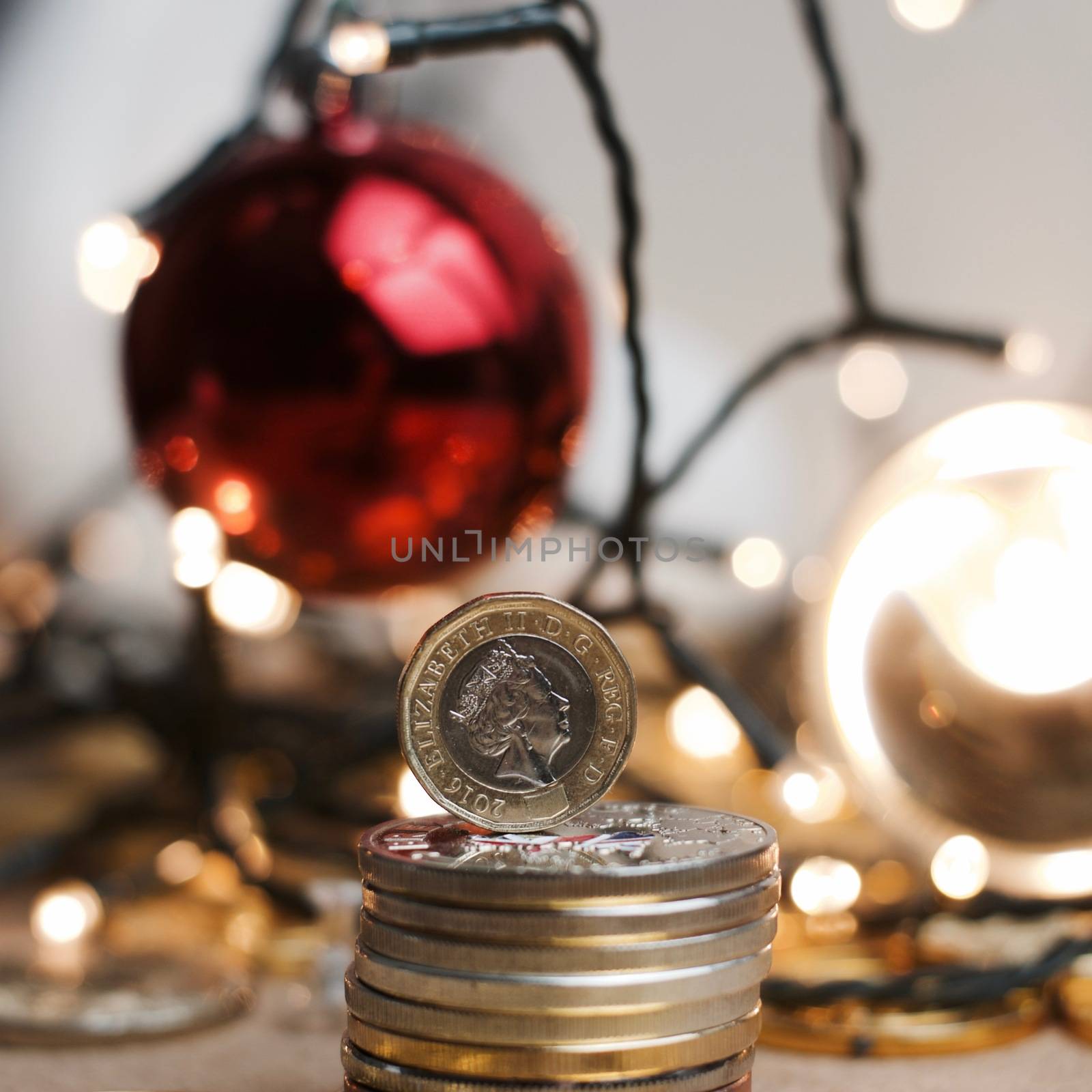 British currency. One pound coin in christmas lights concept.