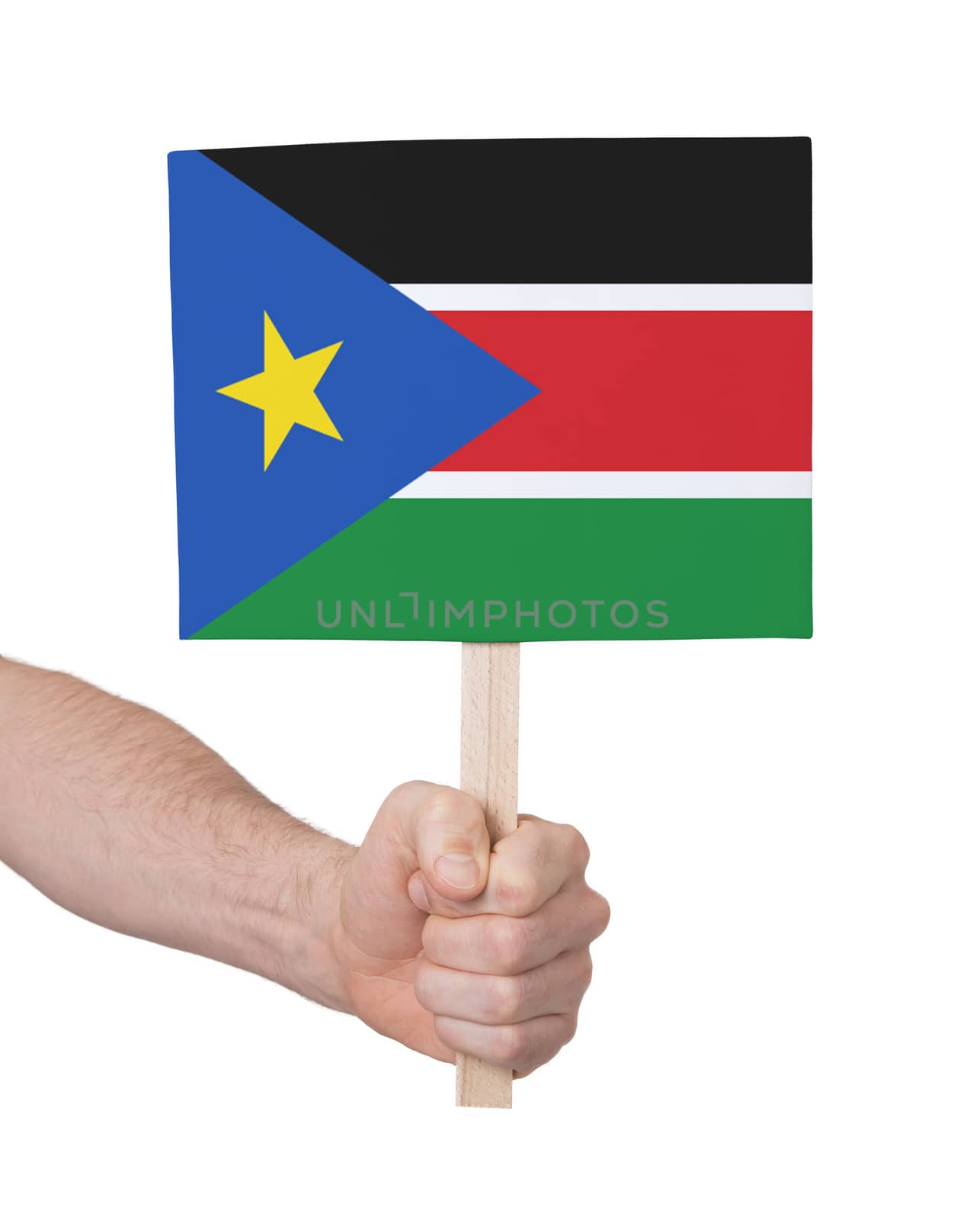 Hand holding small card, isolated on white - Flag of South Sudan