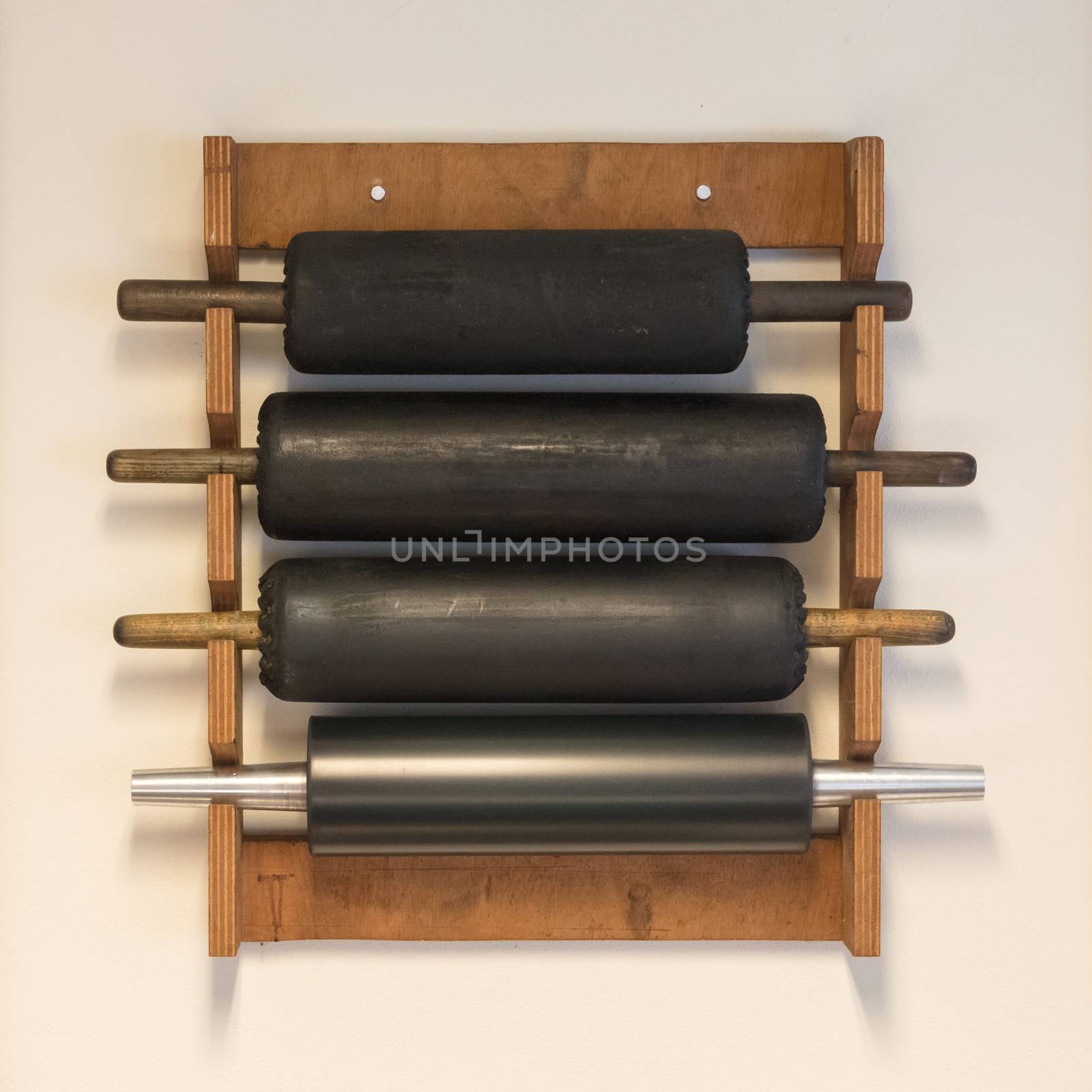 Collection of rolling pins hanging on a wall