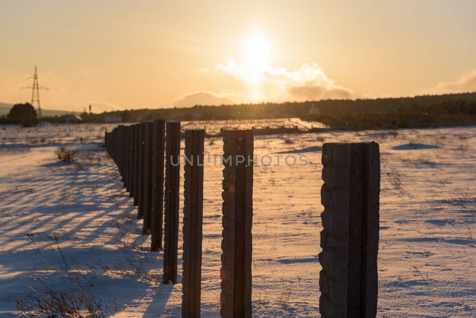 Winter morning landscape dramatic sky snow covered country field.