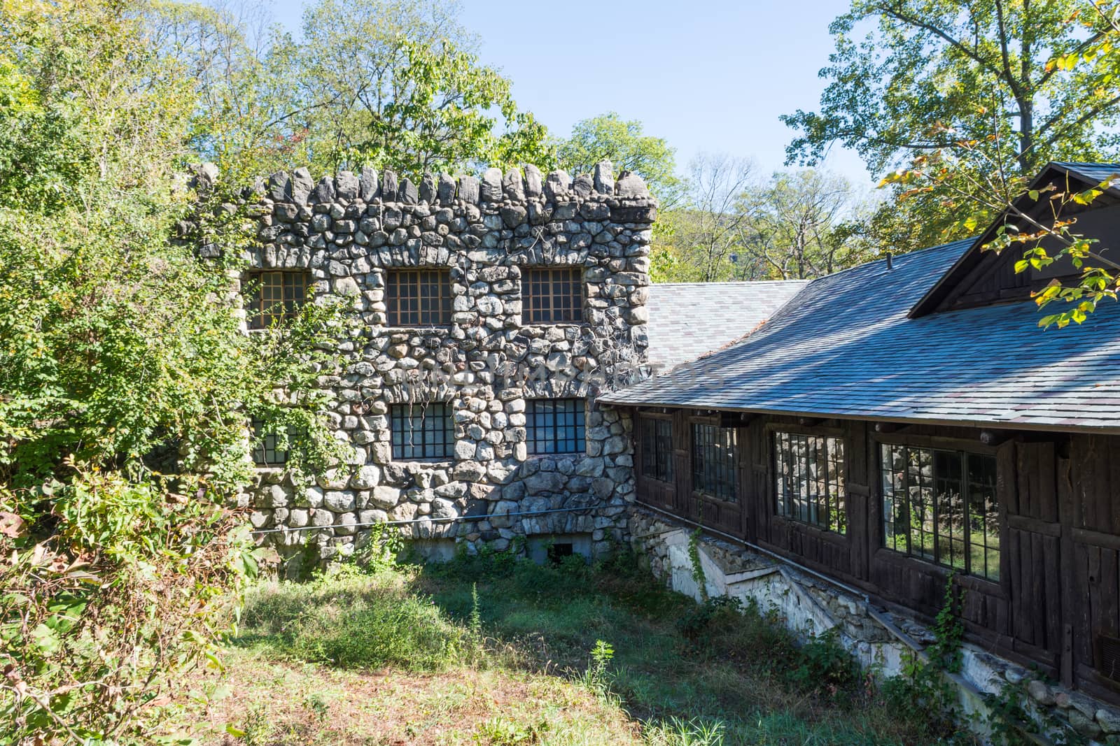 Old  wall lined with small cobblestones, and a wooden stable was attached to it