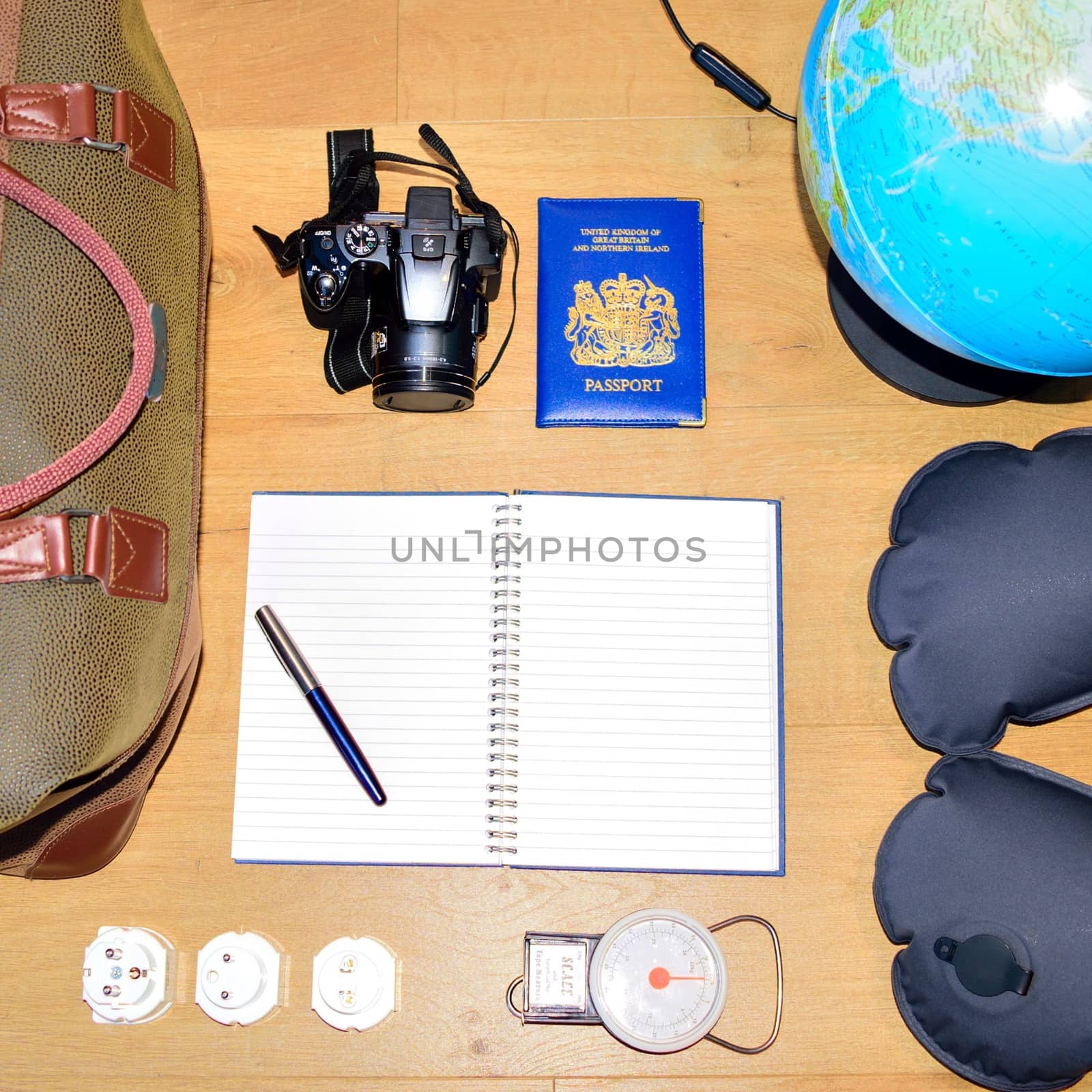 Flat lay of a travel concept, depicting a globe and deciding where to go next.  Creating a bucket list