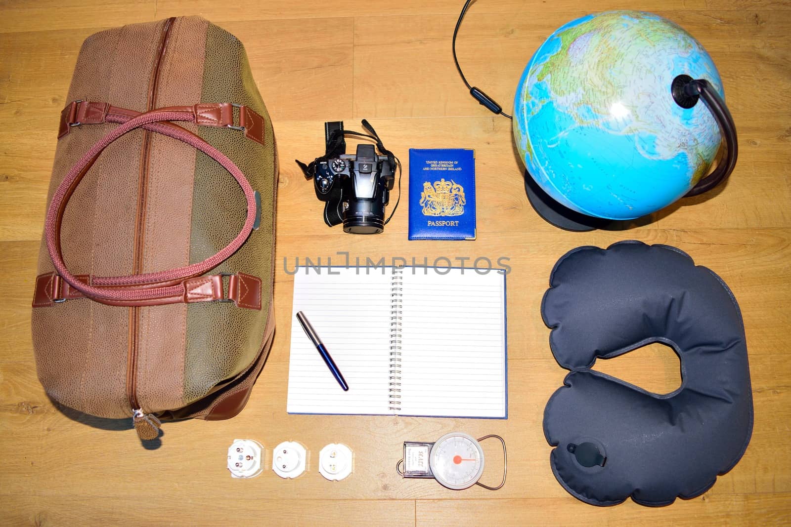 Flat lay of a travel concept, depicting a globe and deciding where to go next.  Creating a bucket list