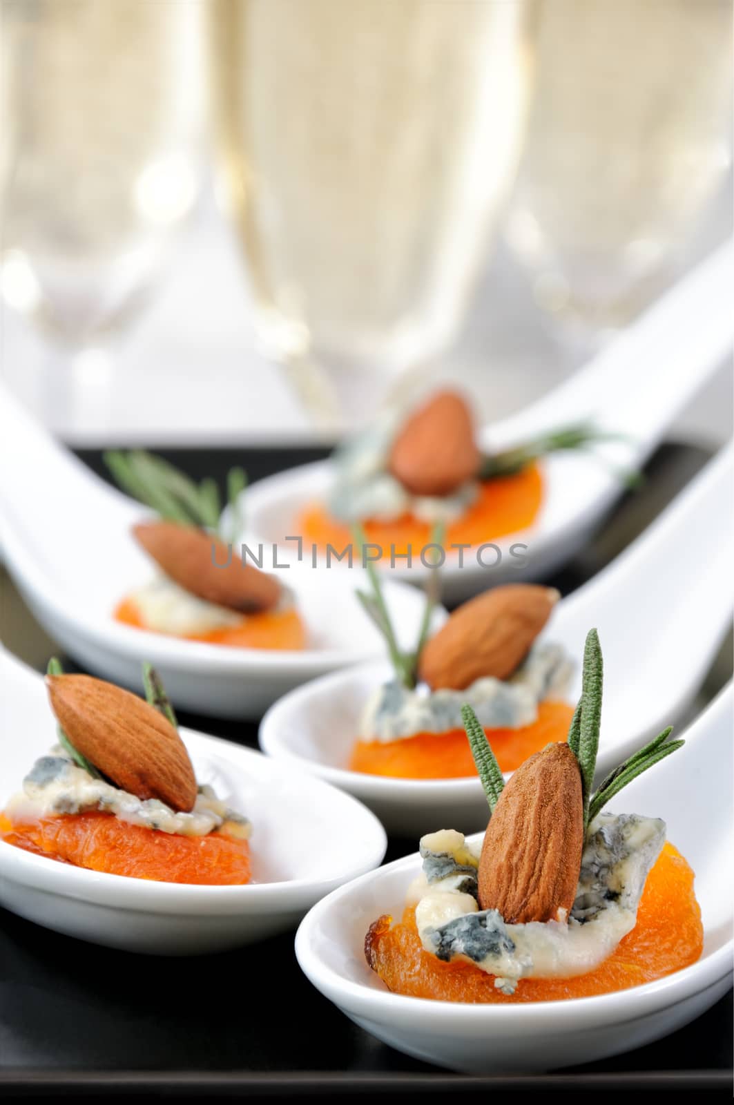 Cocktail snack from dried apricots with gorgonzola and almonds