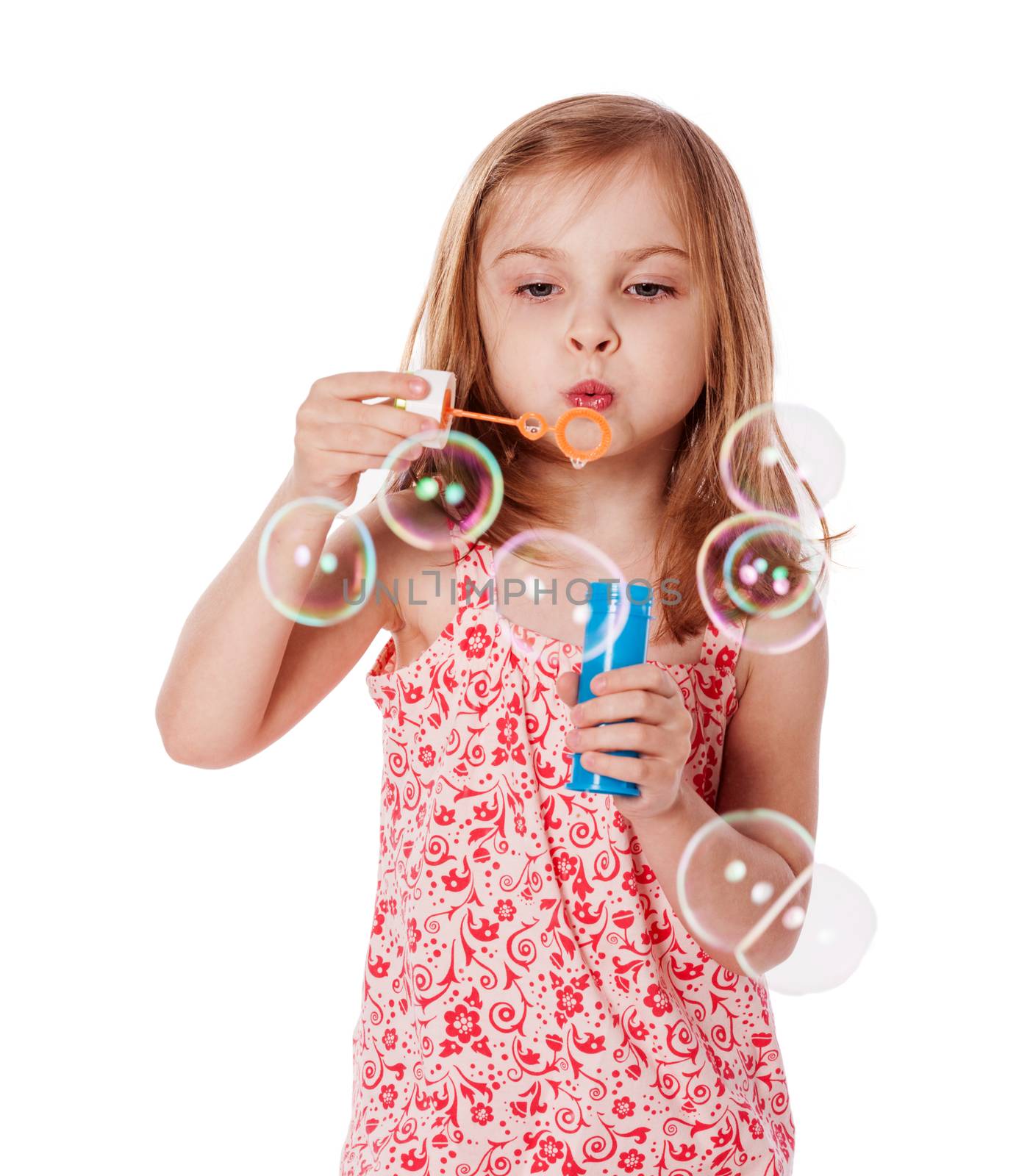 Happy Girl playing with soap bubbles isolated on white