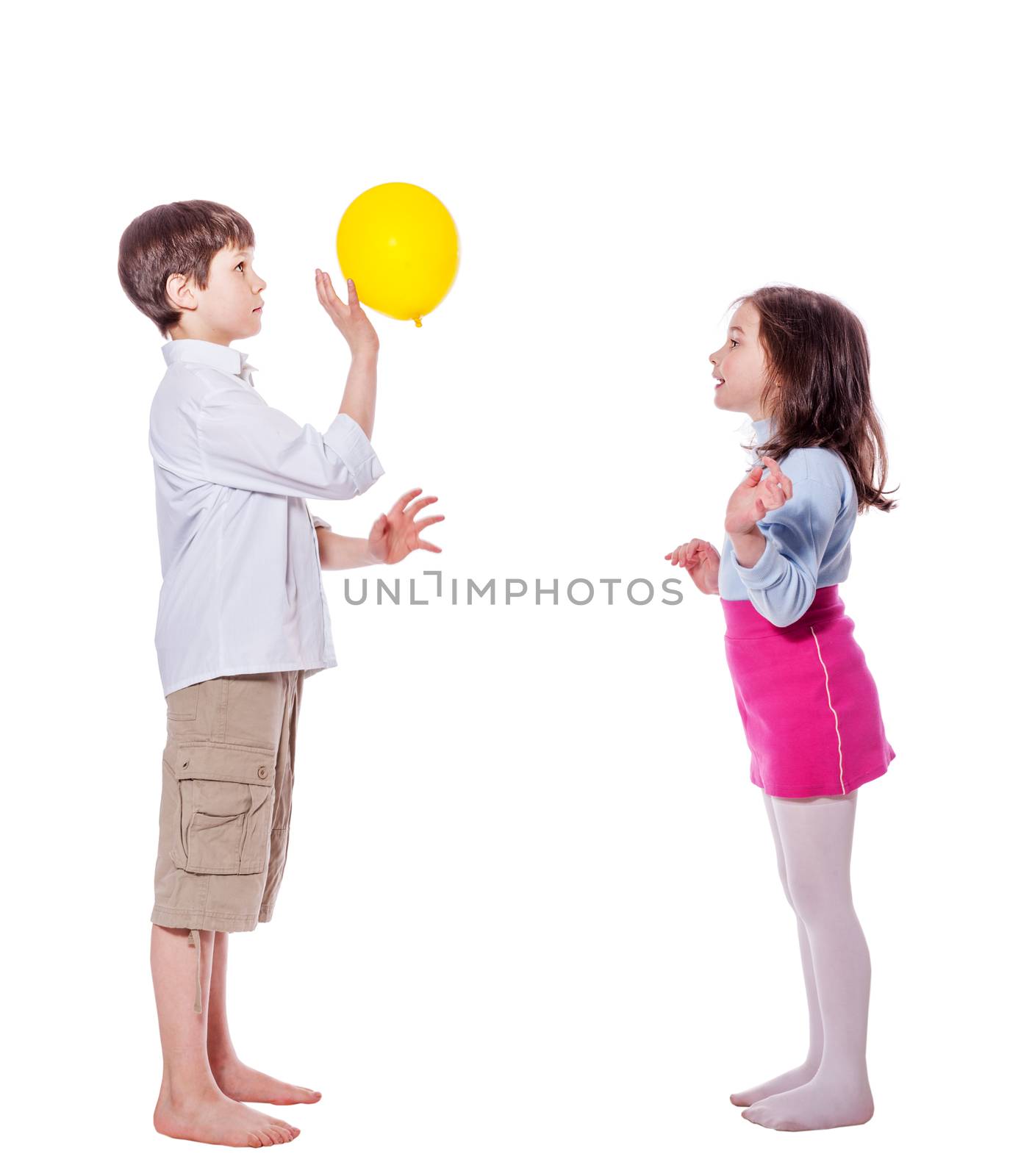 Brother and sister playing with balloons standing isolated on white