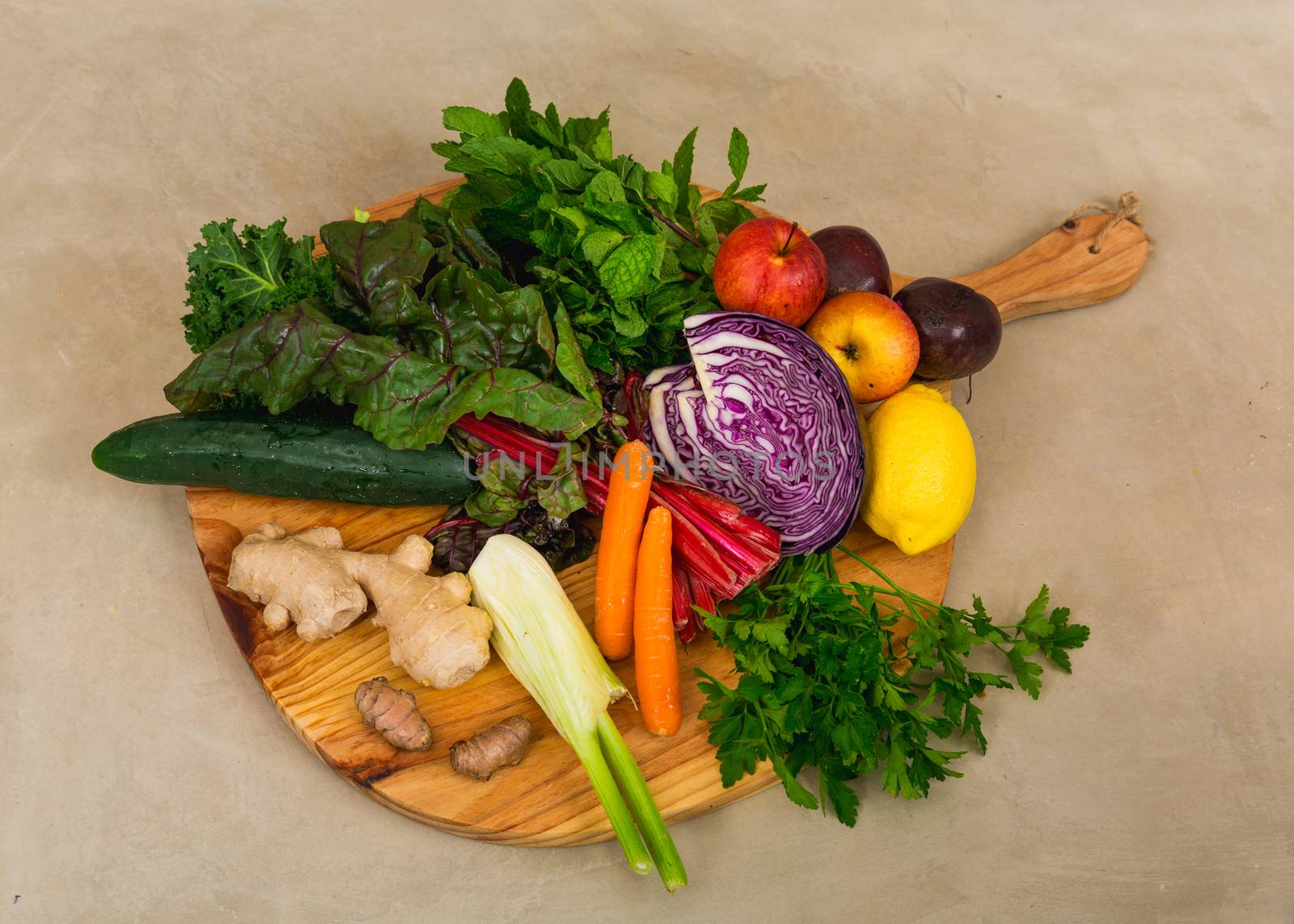 Several vegetables on top of a wooden board. Ingredients for detox diet. 