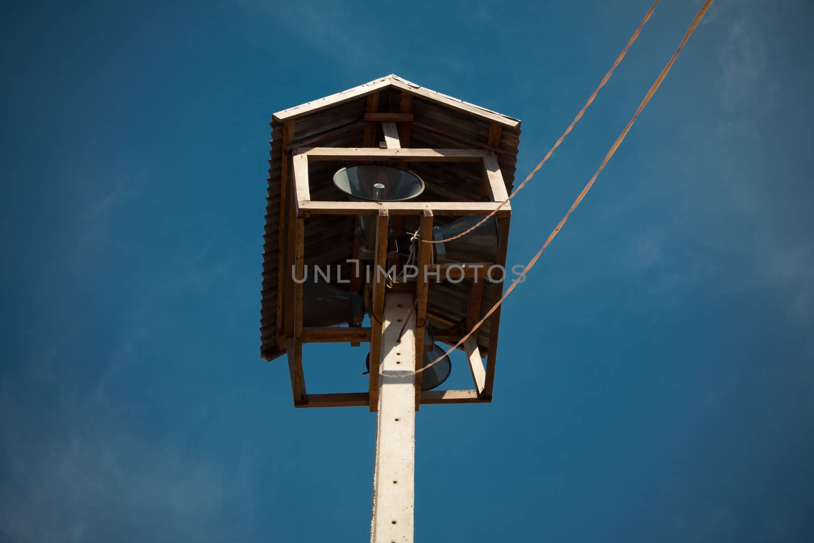Old public loudspeakers broadcast on high tower with long distance tower