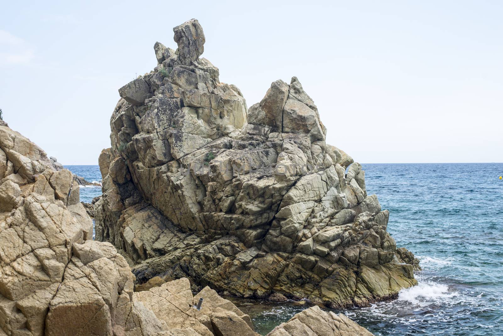 Huge stone mountain on sky background with sea