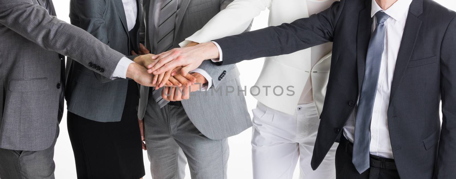 Group of business people crossed arms in pile for win. Stack of hands. Cooperation concept