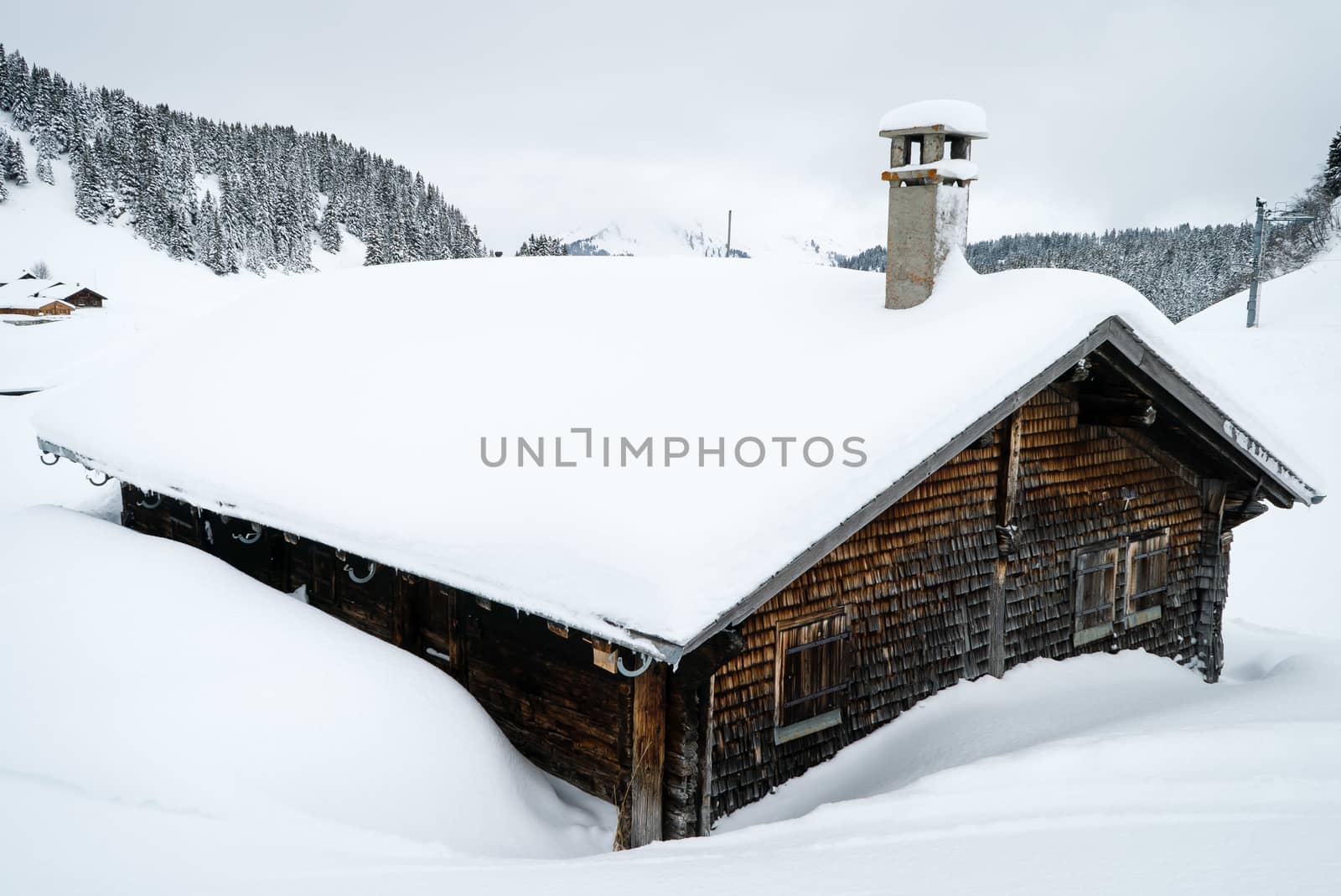 Chalet covered with snow in Villars-sur-Ollon in Switzerland