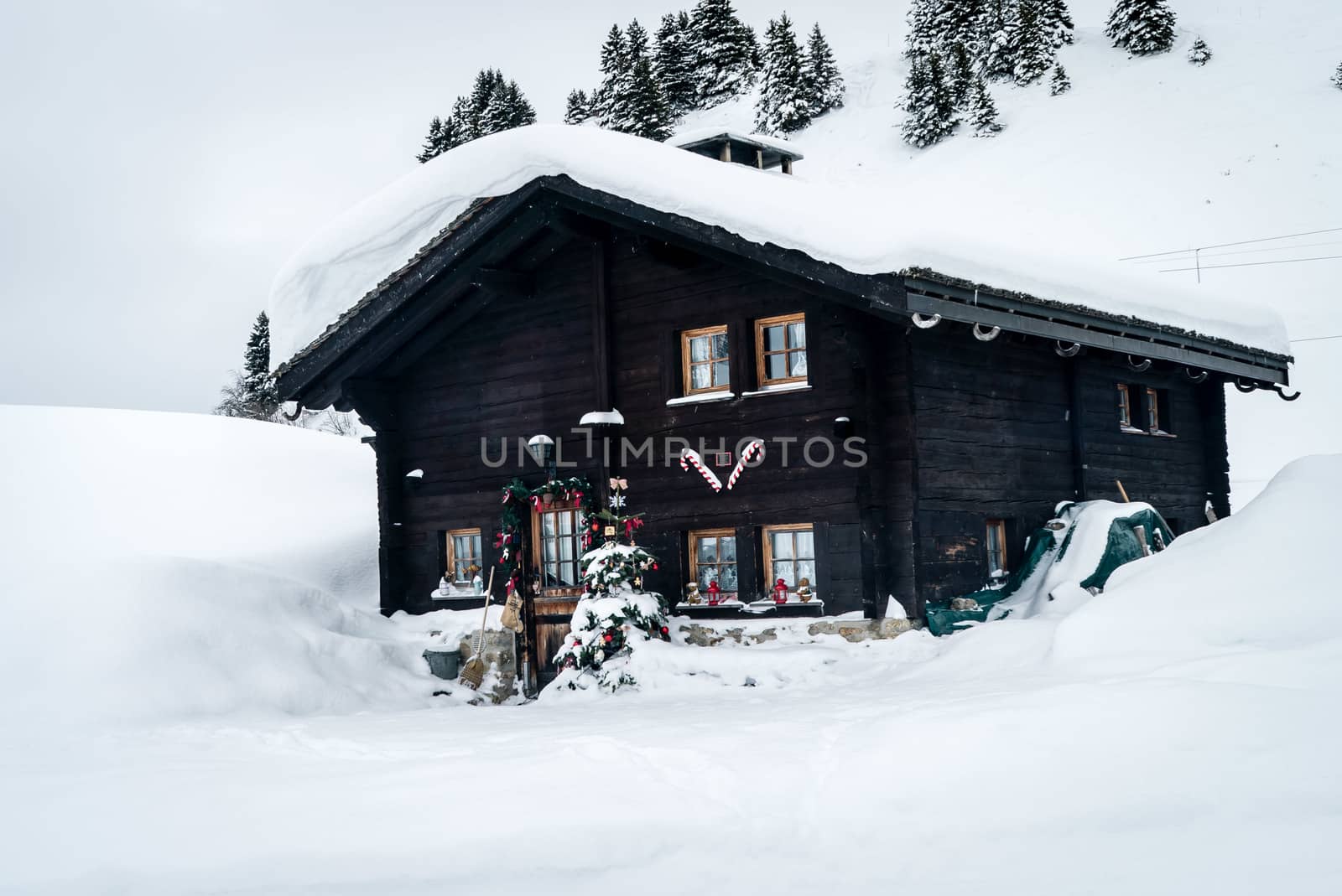 Chalet covered with snow and decorated with Christmas objects