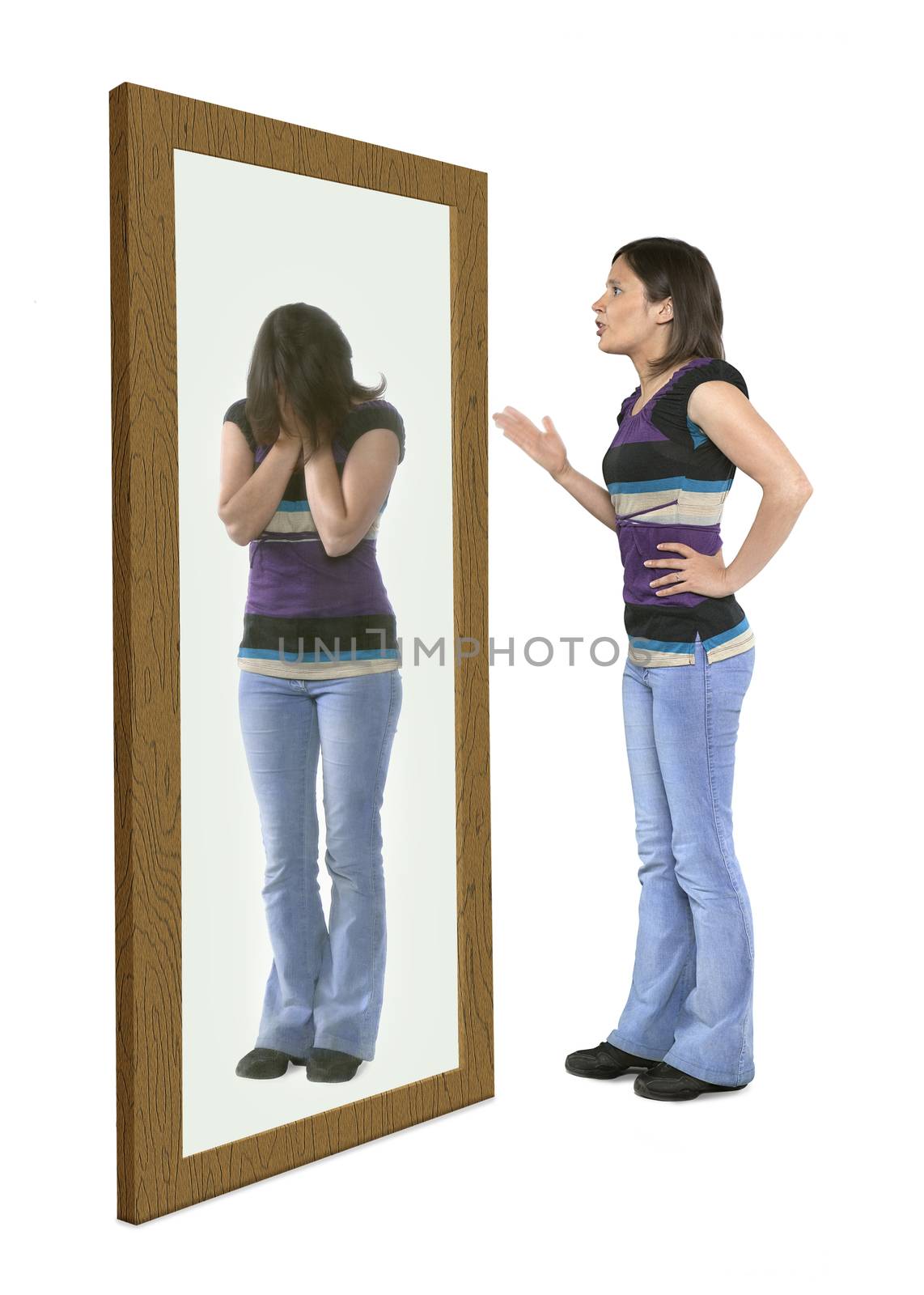 Woman scolding herself in a mirror, herreflection crying