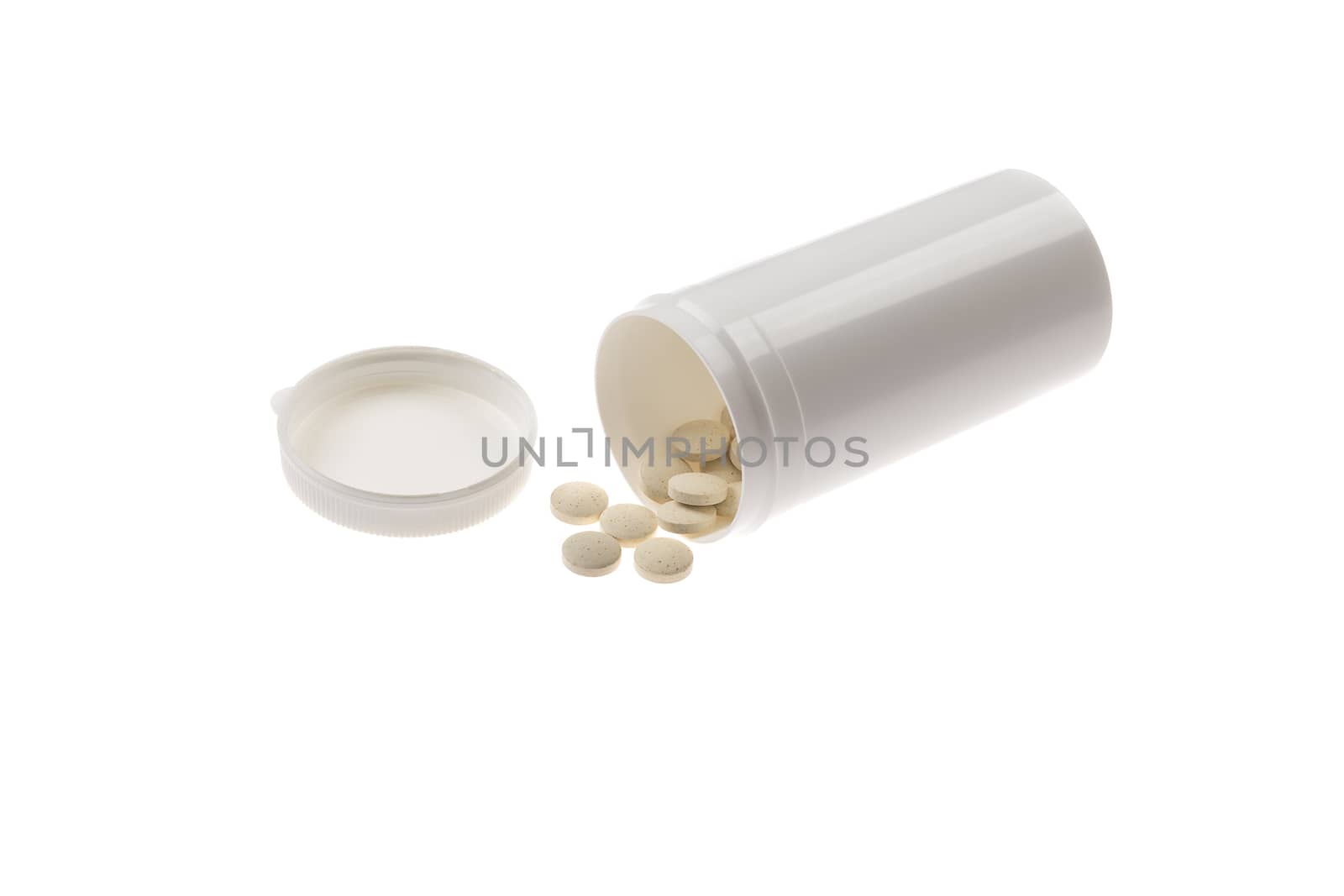 pills spilled from pills bottle. Pills and medicine container lying on white background.