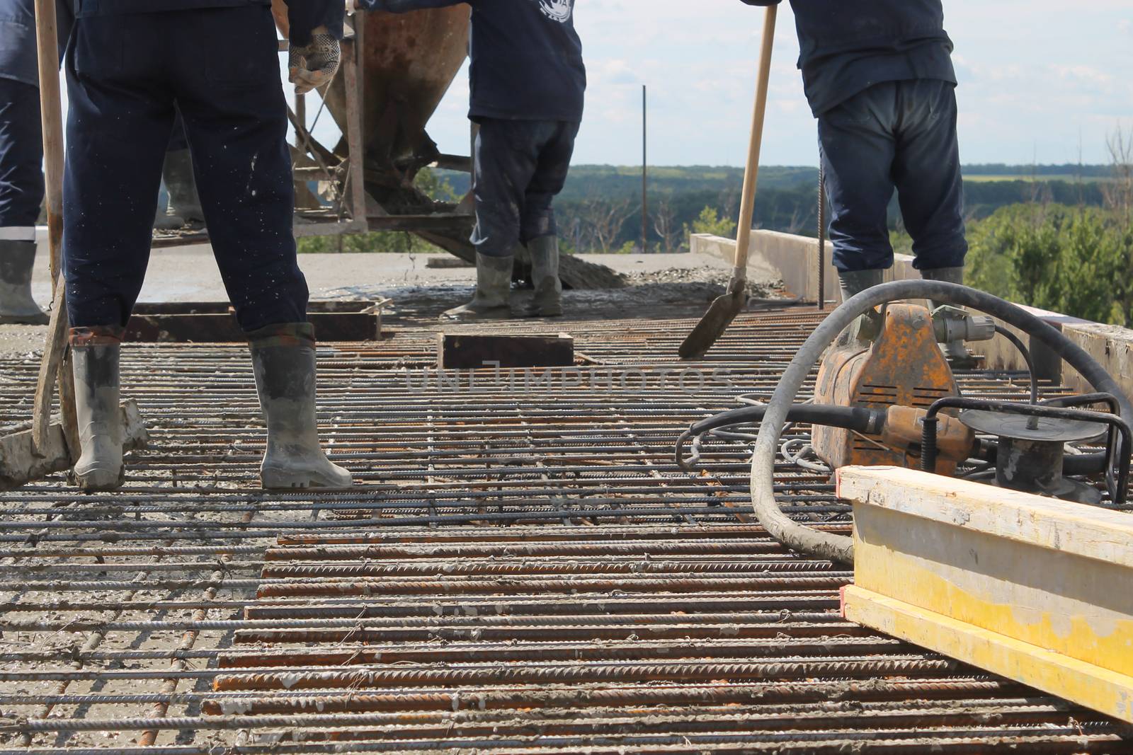 workers at the construction site poured concrete floor by nolimit046