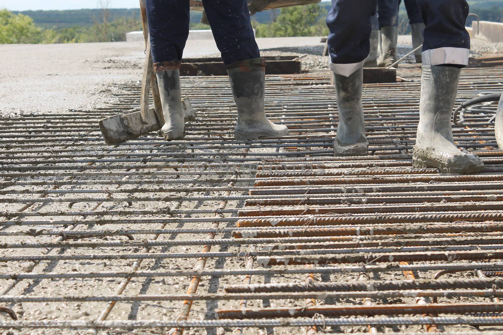 workers at the construction site poured concrete floor.