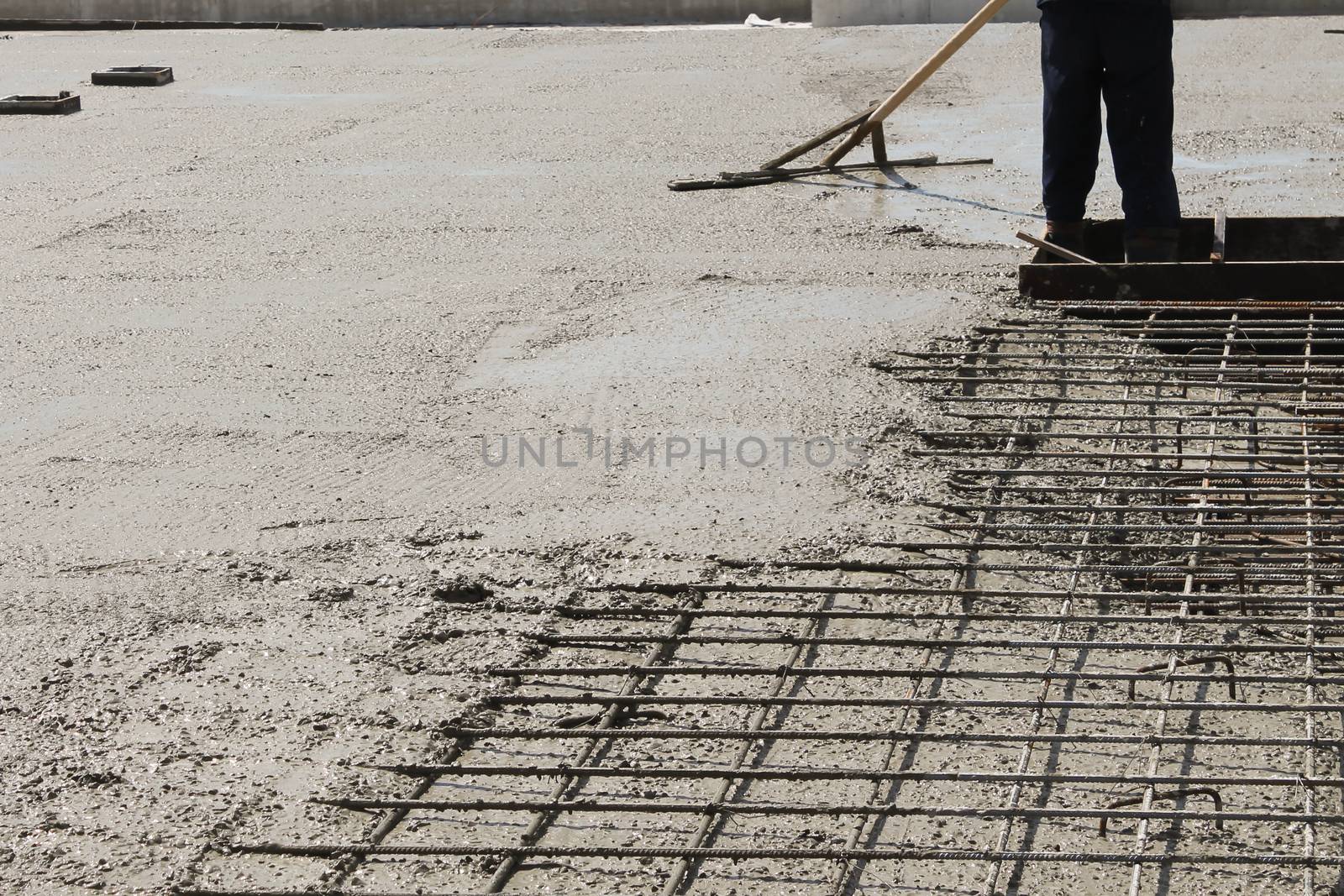 workers at the construction site poured concrete floor.