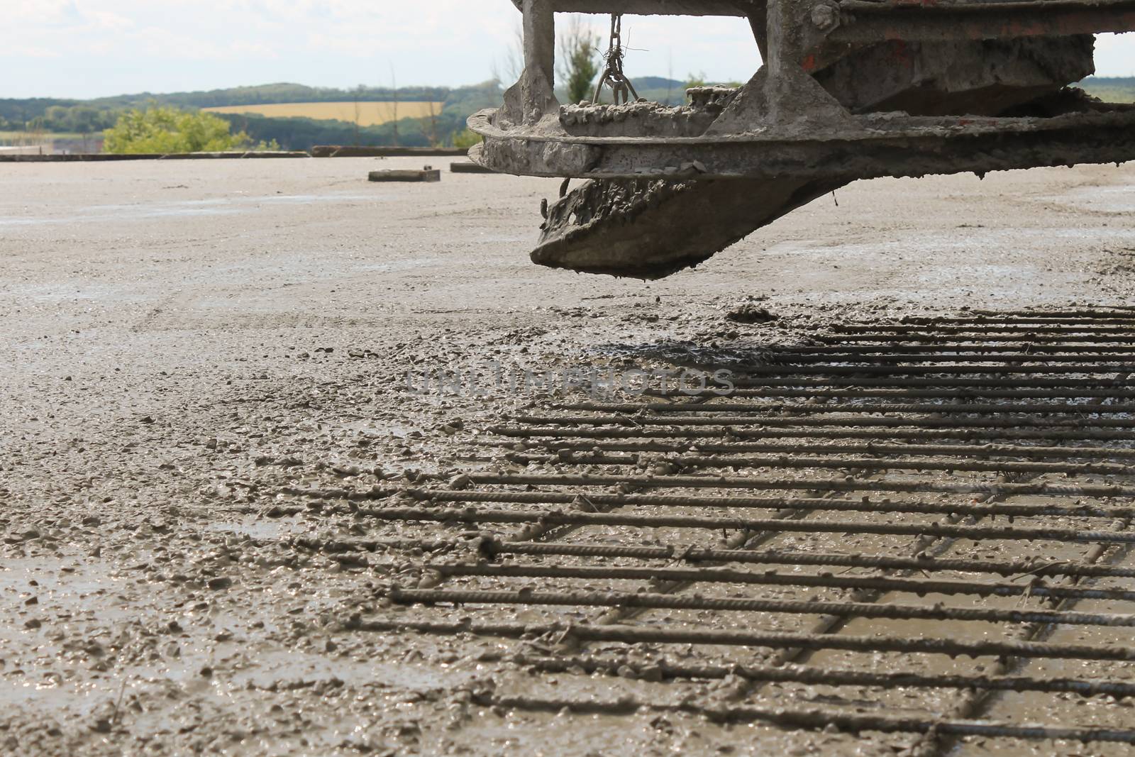 workers at the construction site poured concrete floor.