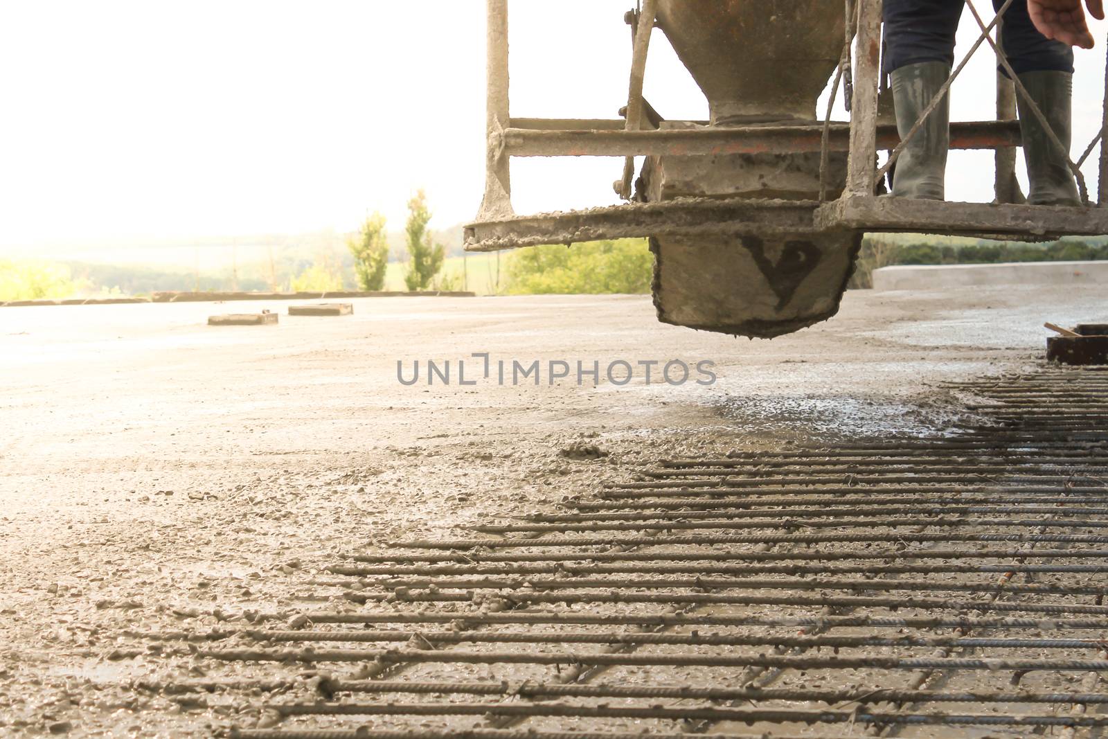 workers at the construction site poured concrete floor.