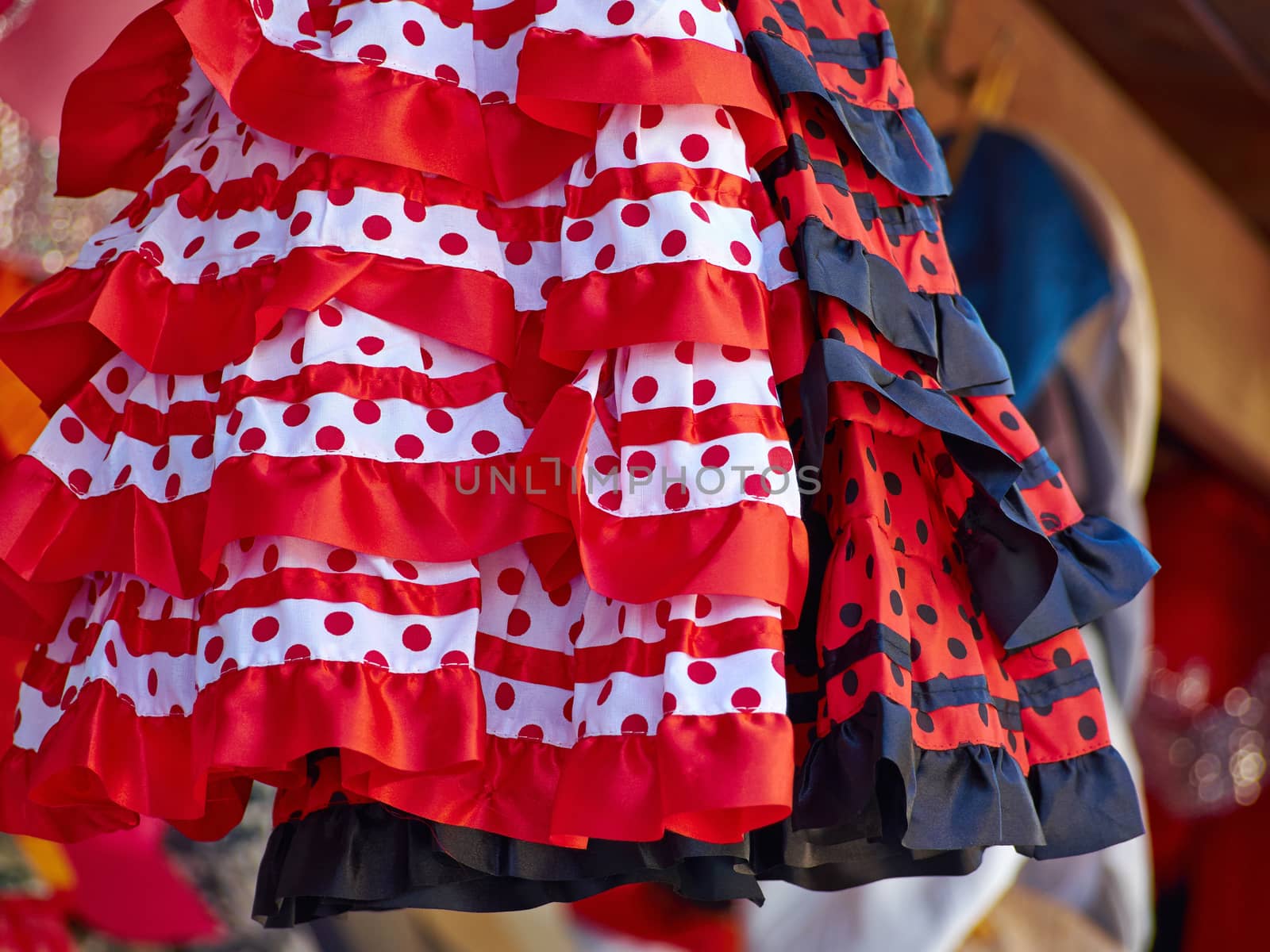 Beautiful traditional red flamenco dress hanged for display in a shop Spain