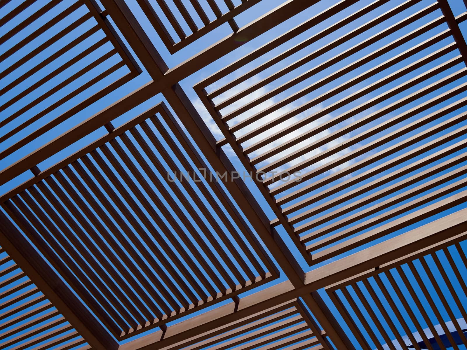 Modern design pergola arbor made wood and metal with clear blue summer sky background