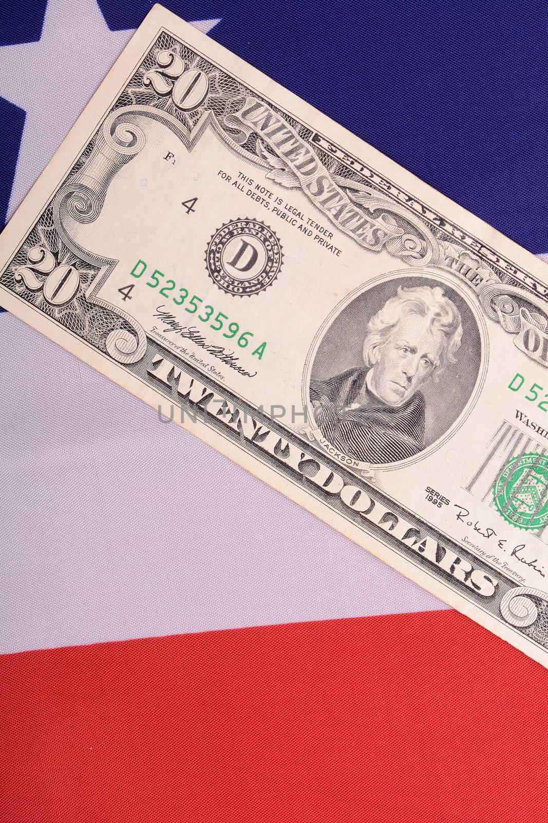 twenty dollar bill in front of the American flag