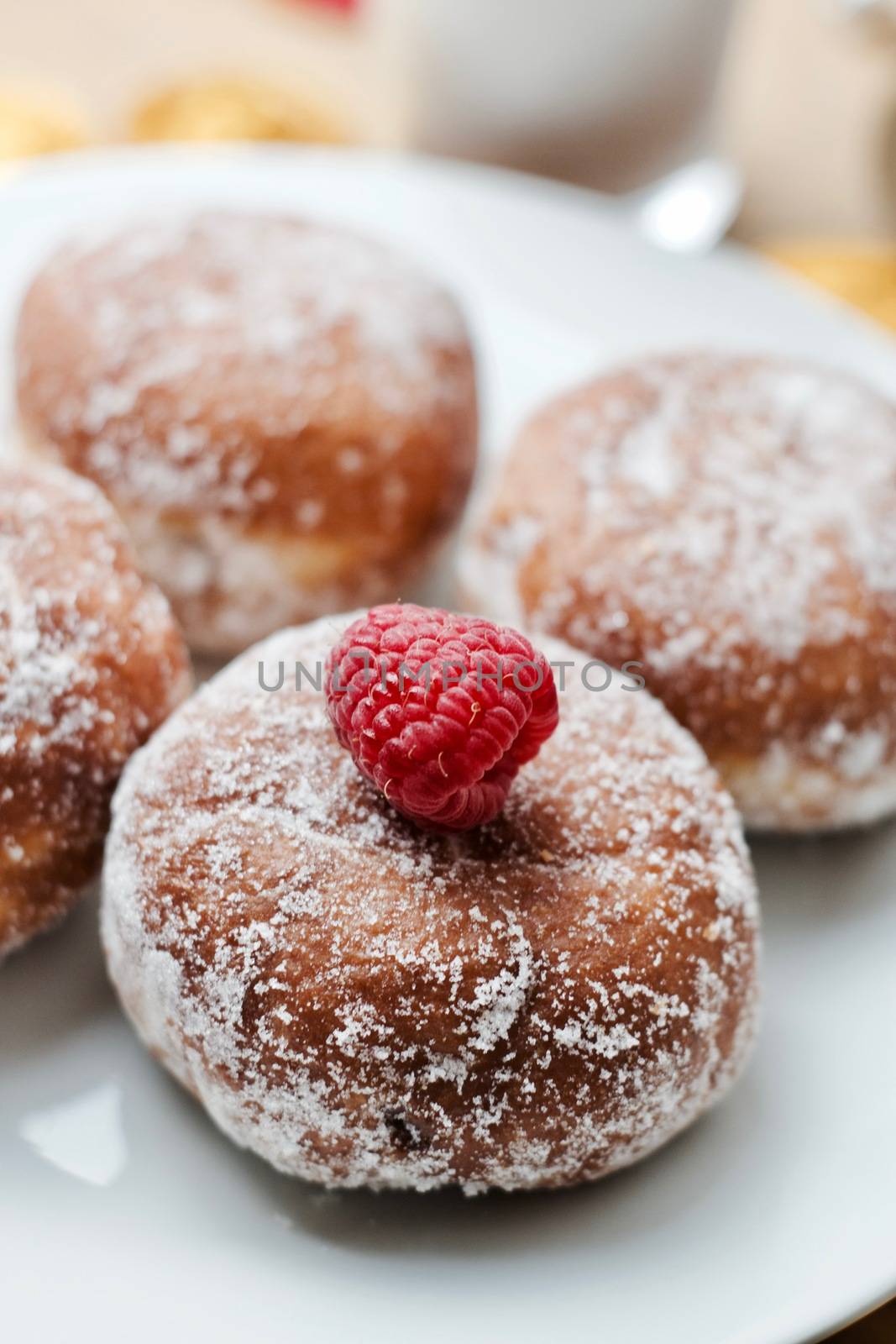 Delicious doughnuts on the white plate. Sweet fresh food concept.