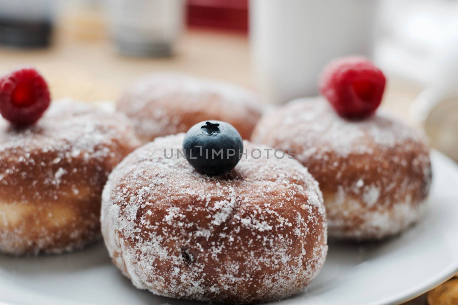 Delicious doughnuts on the white plate. Sweet fresh food concept.