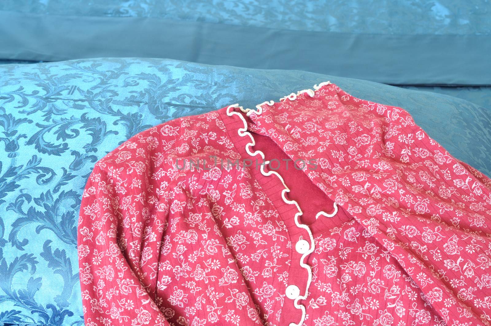 red woman pajamas on blue sheets