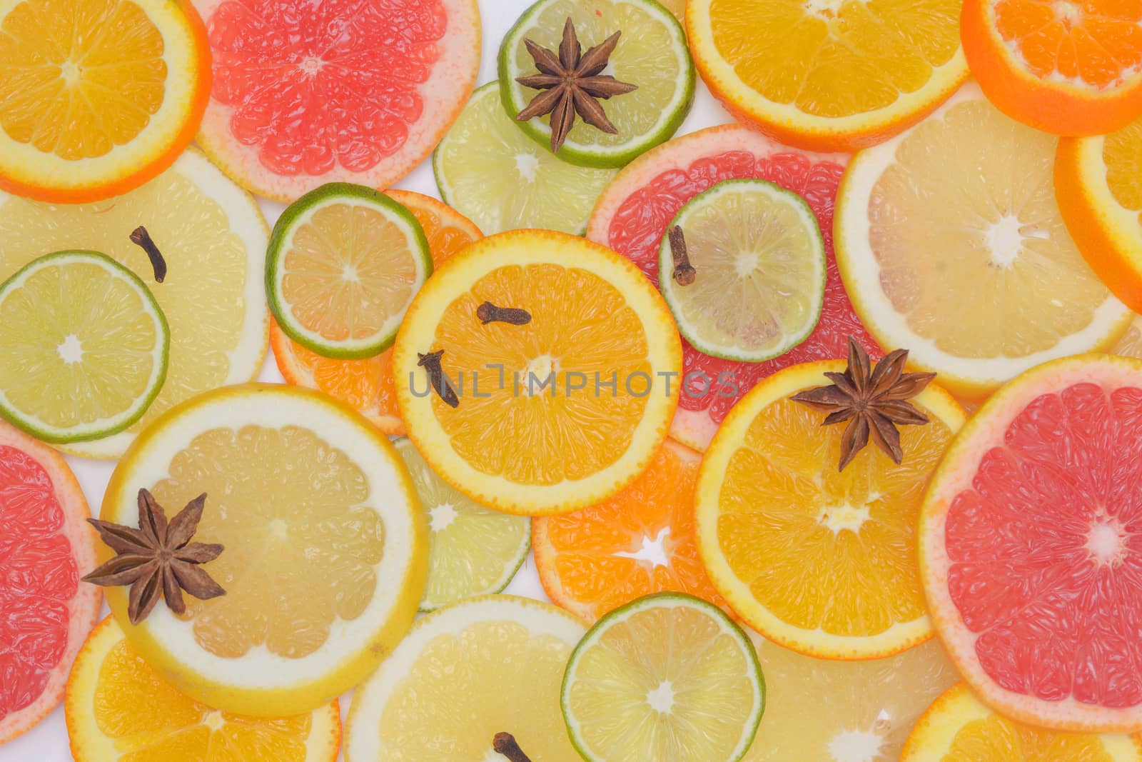 Background with citrus fruit slices, anise star and Clove