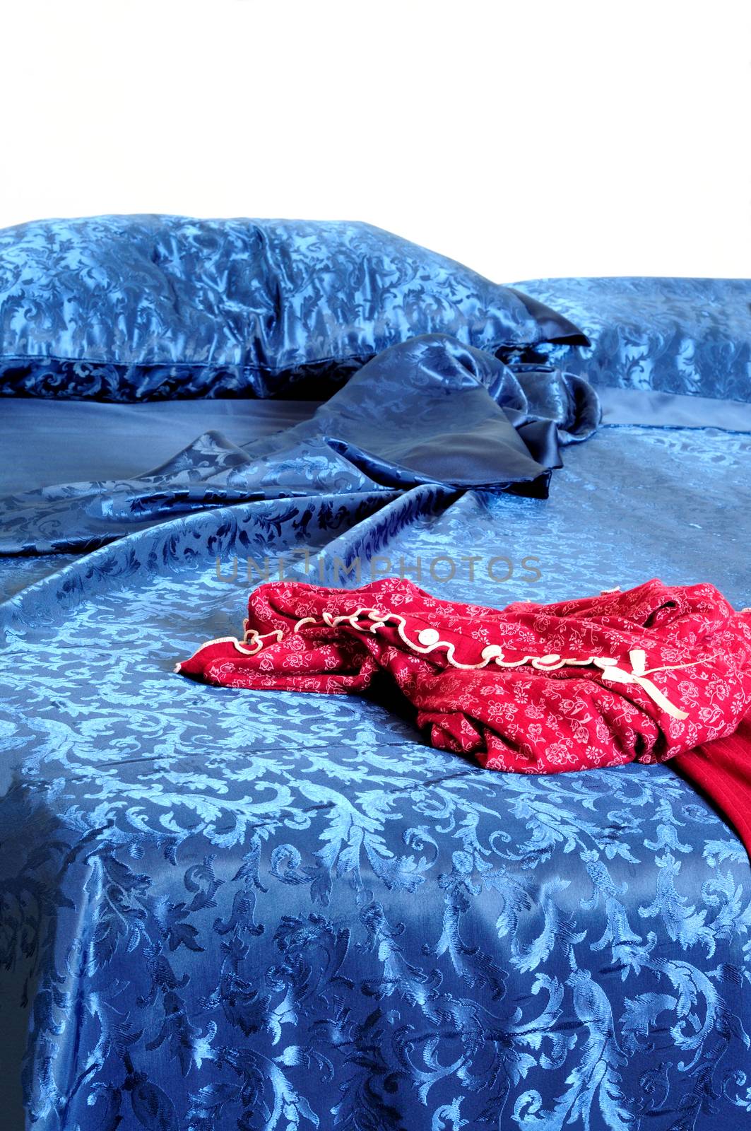 woman red pyjamas on messy bed,vertical