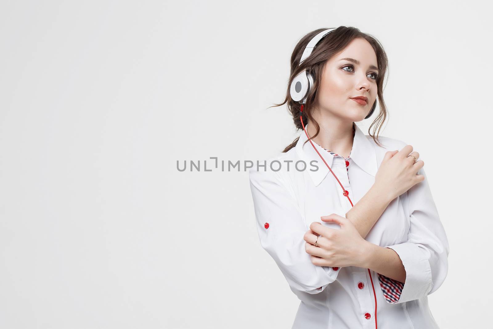 Happy Girl Listen Music in White Headphones and Smiling by 3KStudio