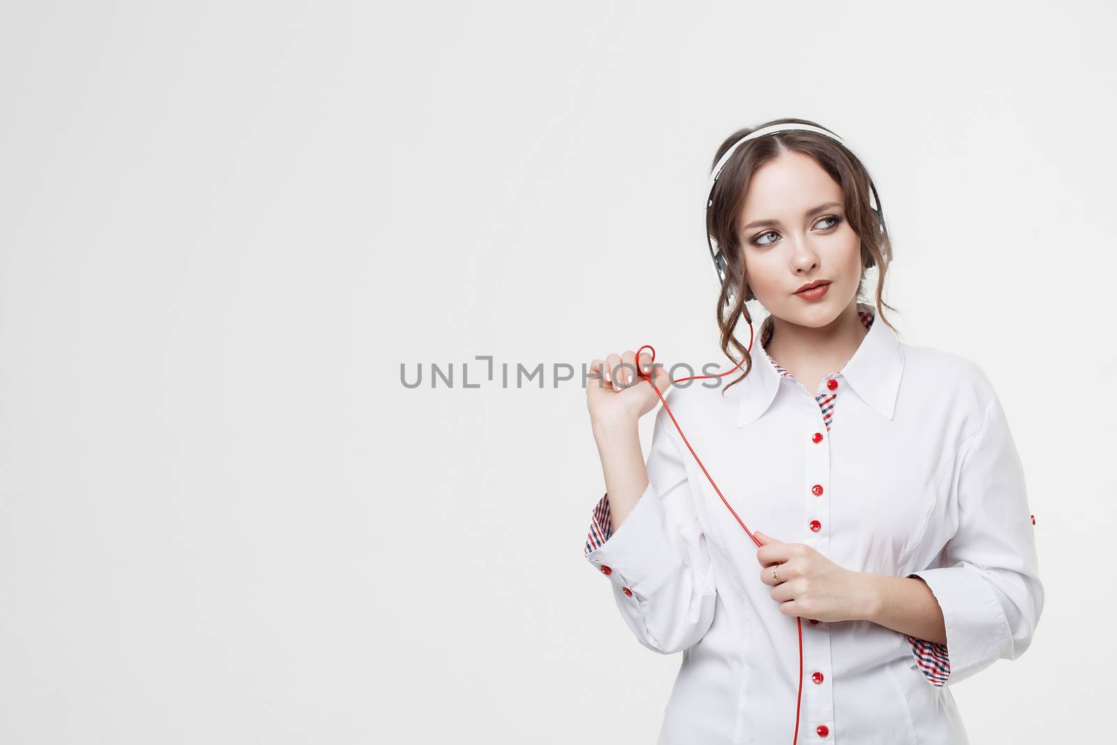 Happy Girl Listen Music in White Headphones and Smiling by 3KStudio