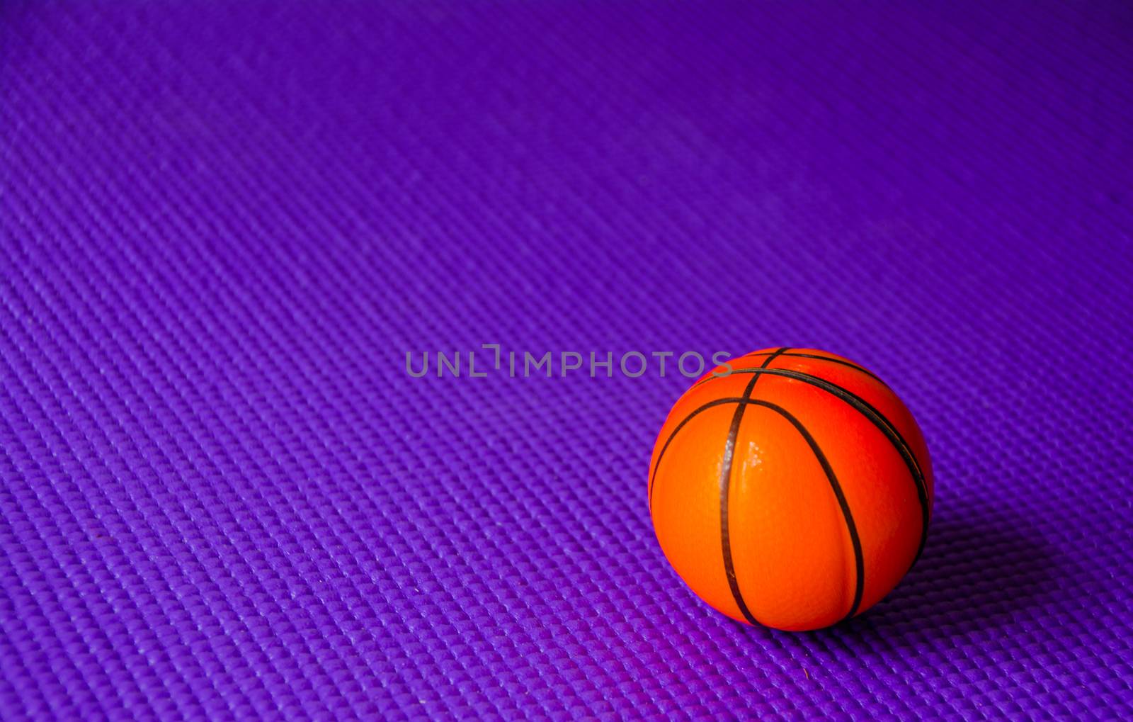 Small Basketball on purple yoga mat