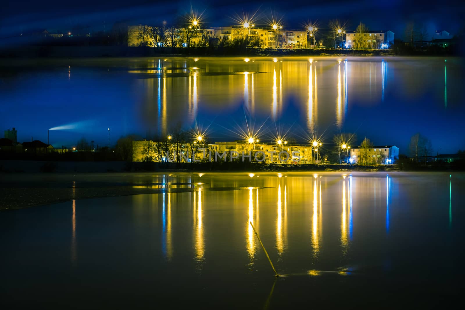 night landscape of a city reflection in the water photo with a shutter speed of Siberia winter