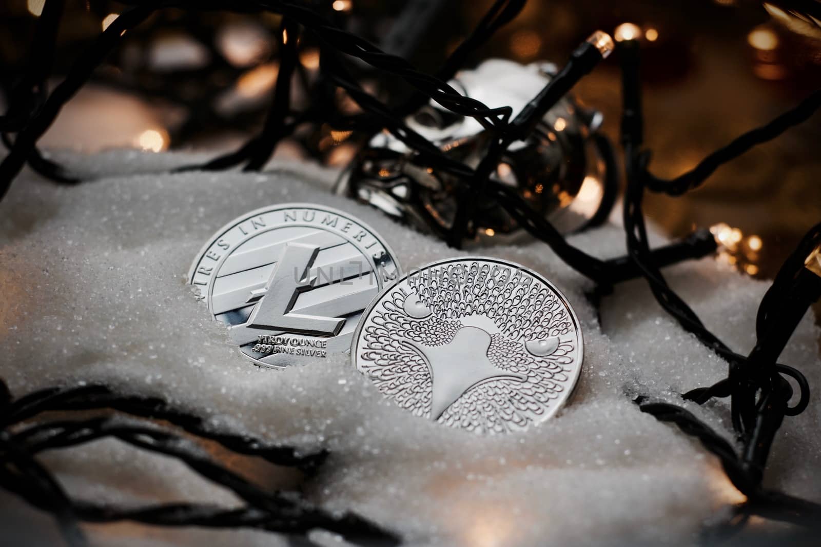 Digital currency physical metal bitcoin coin. Crypto currency christmas snow composition.