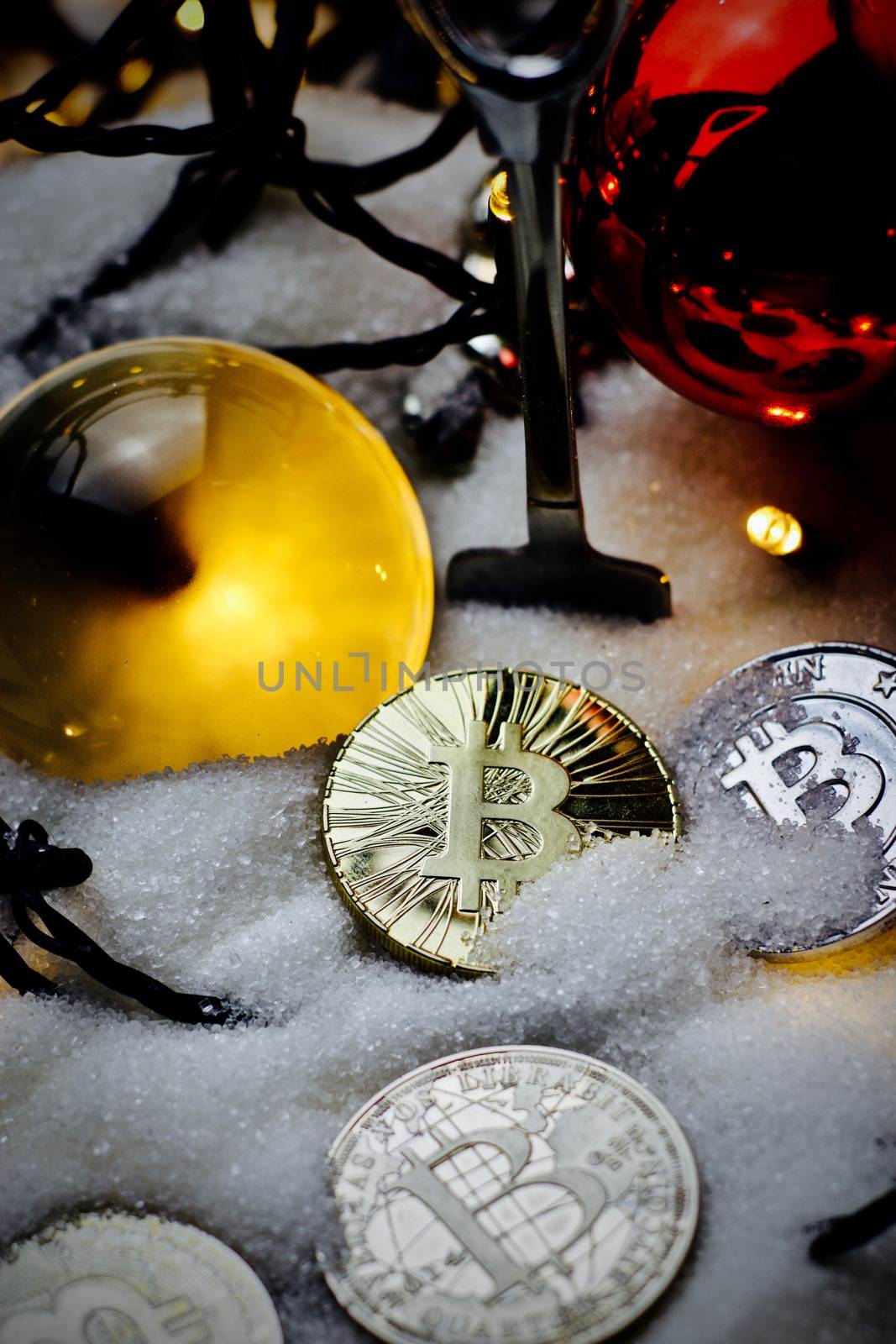 Digital currency physical metal bitcoin coin. Crypto currency christmas snow composition.