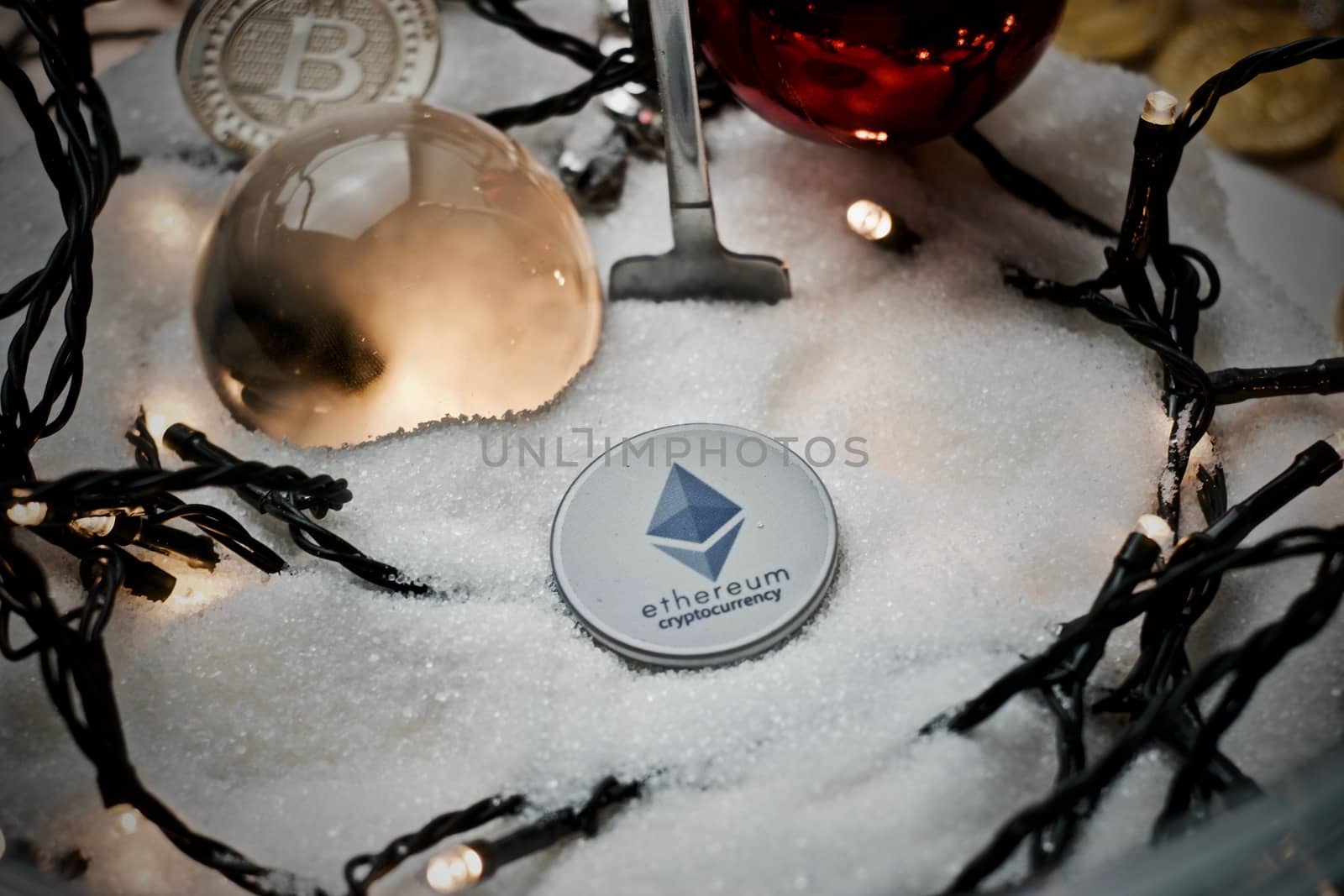 Digital currency physical grey ethereum token. Christmas snow concept.