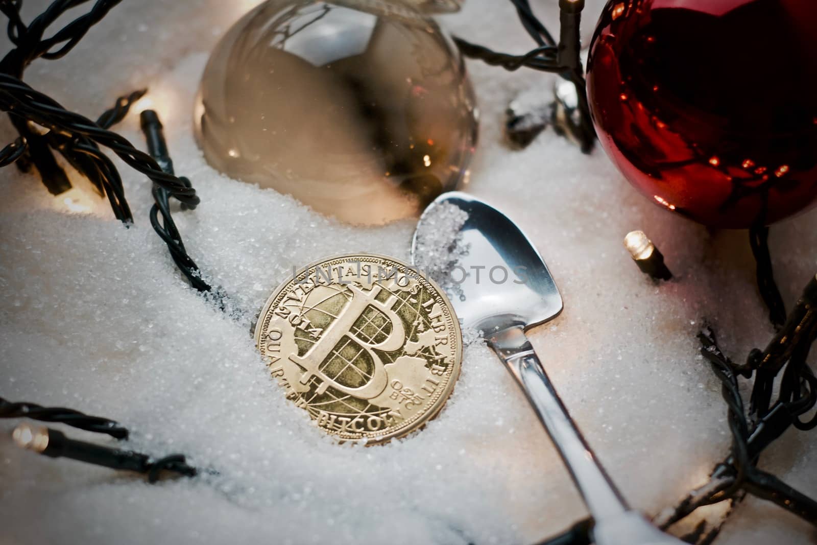 Digital currency physical metal bitcoin coin. Crypto currency christmas snow composition.