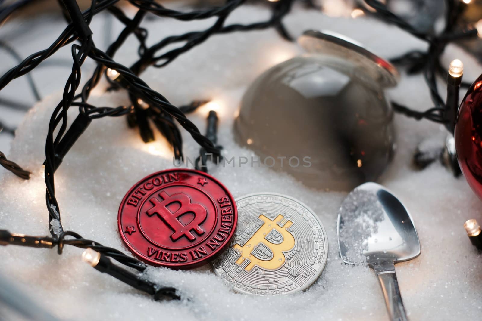 Digital currency physical metal bitcoin coin. Crypto currency christmas snow composition.