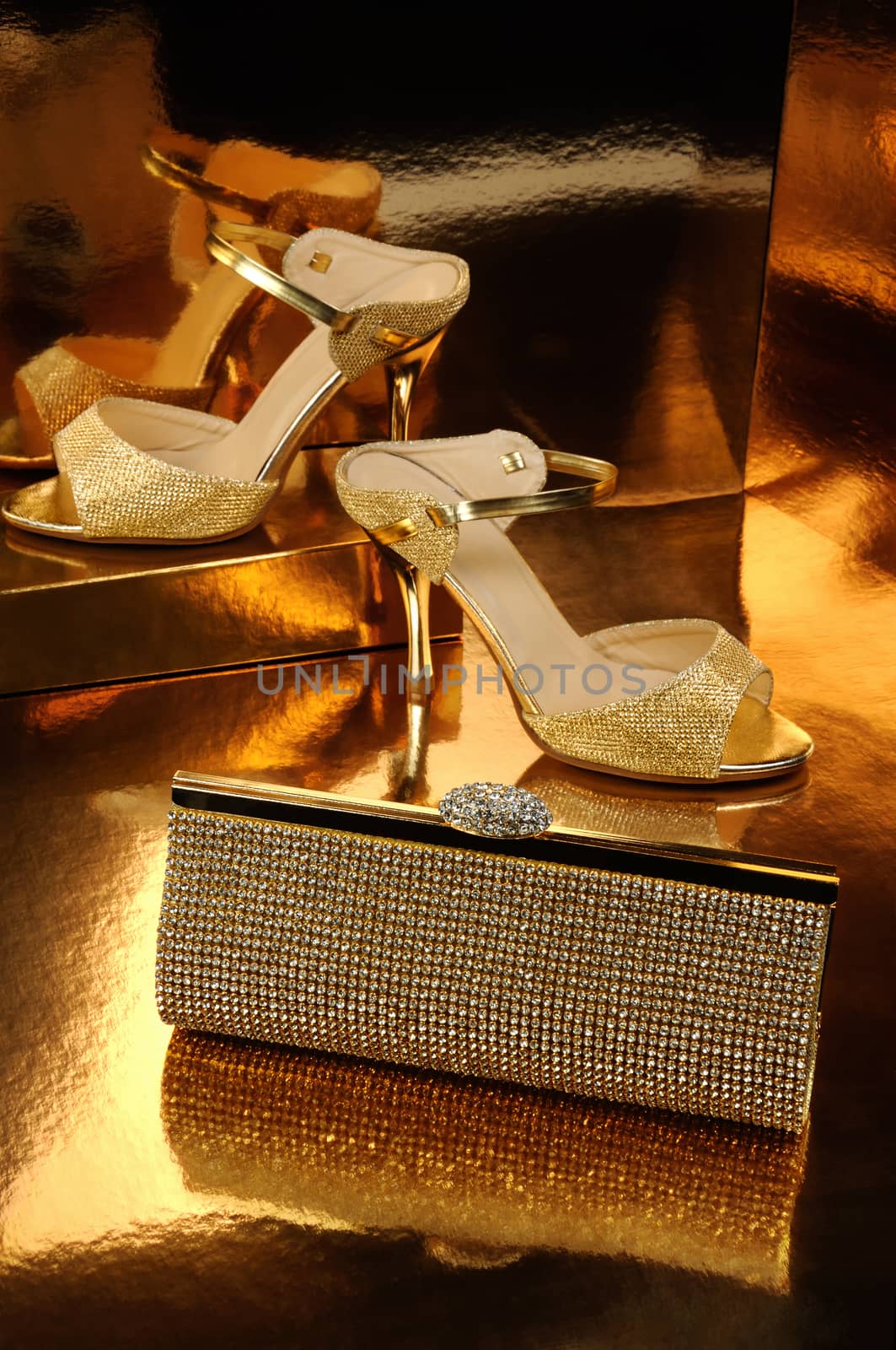 Golden clutch inlaid with rhinestone and a pair of gold shoes