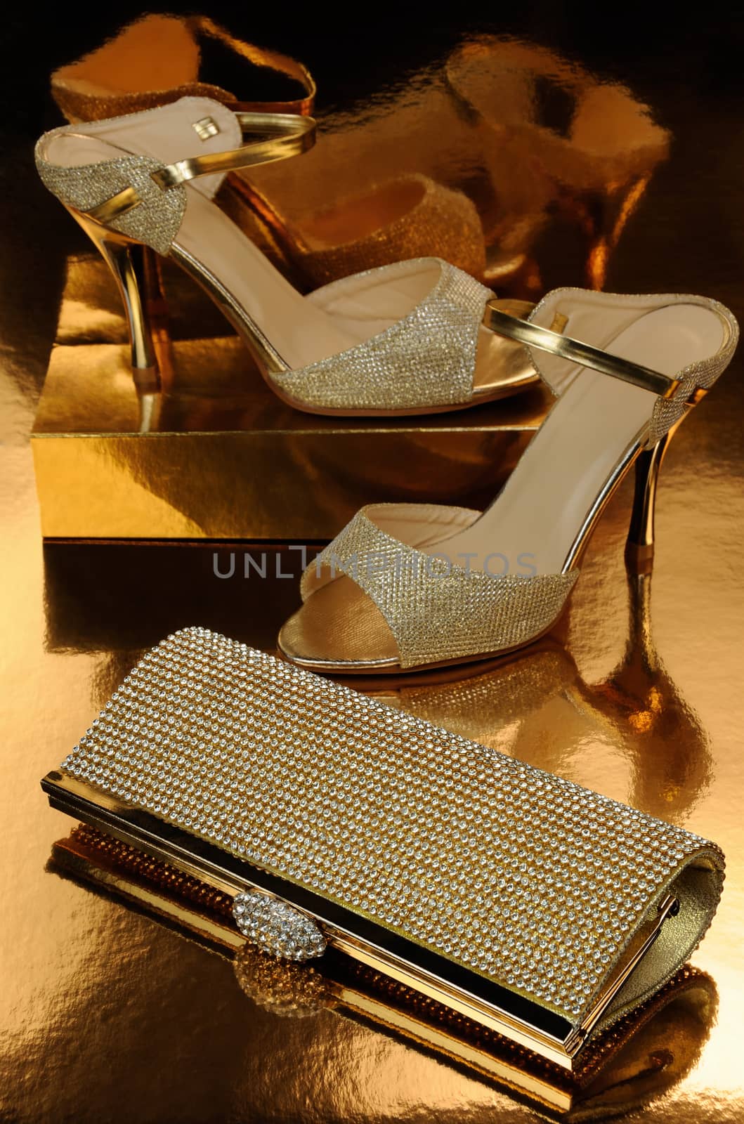 Golden clutch inlaid with rhinestone and a pair of gold shoes