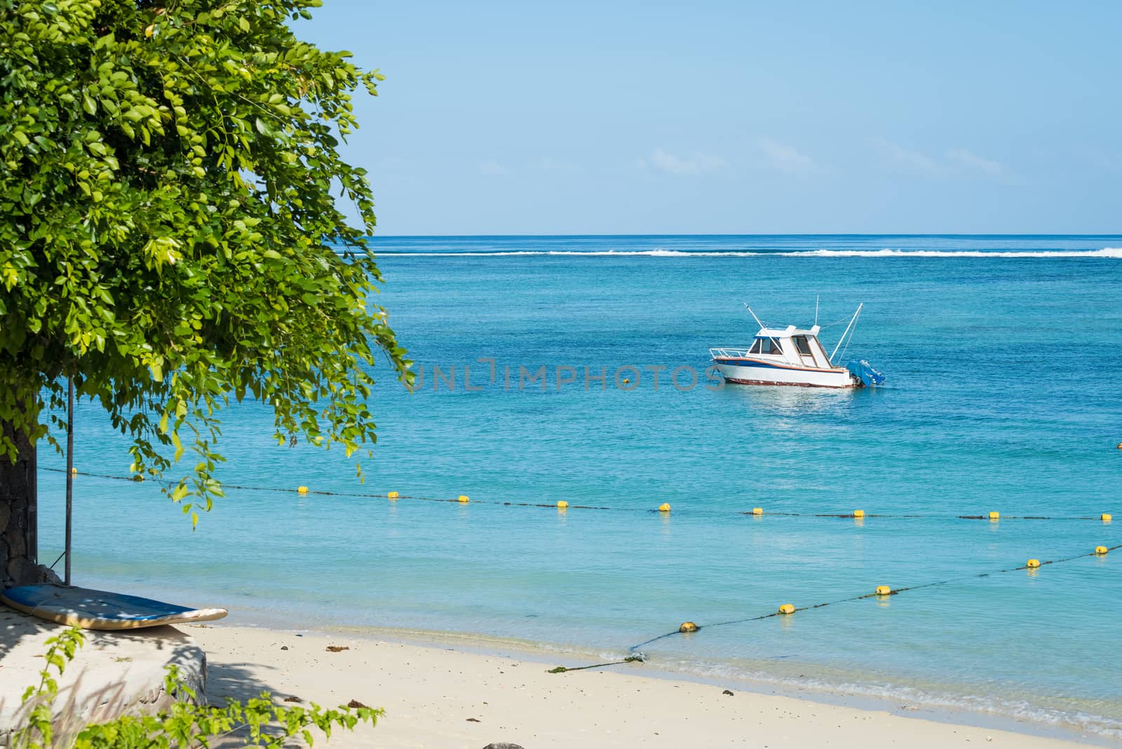 Fishing boat anchored near the shore of day beach,mauritius beach Flic and Flac.