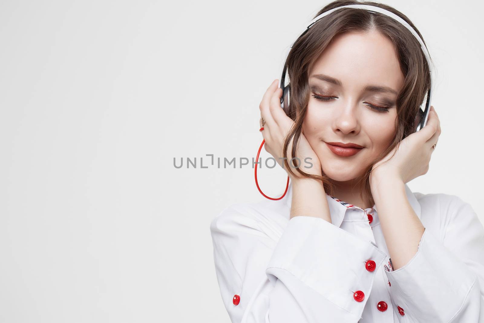 Beautiful girl in headphones listens to music. Slow motion.