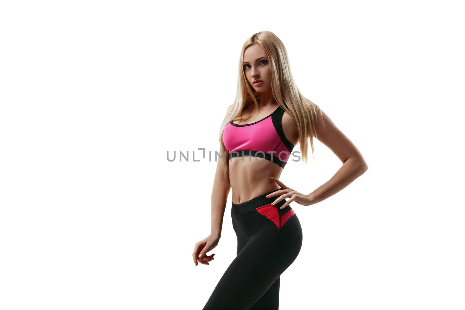 Portrait of a beautiful young blond fitness woman in sportswear isolated on white background