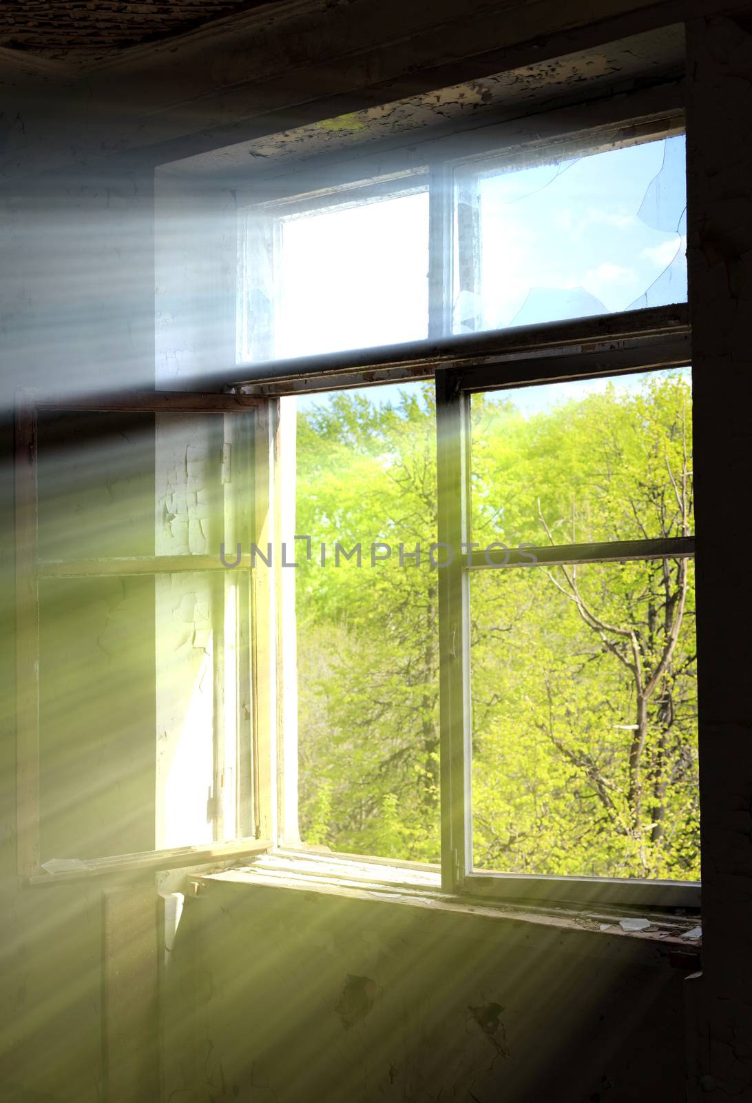 Window of an old ruined structure with bright sun rays