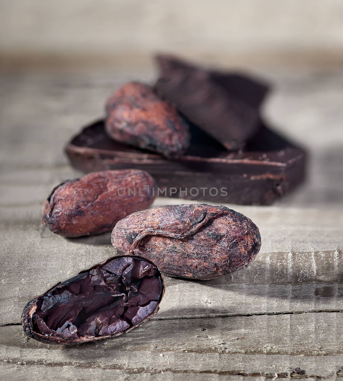 Cocoa beans and piece of dark chocolate by Cipariss