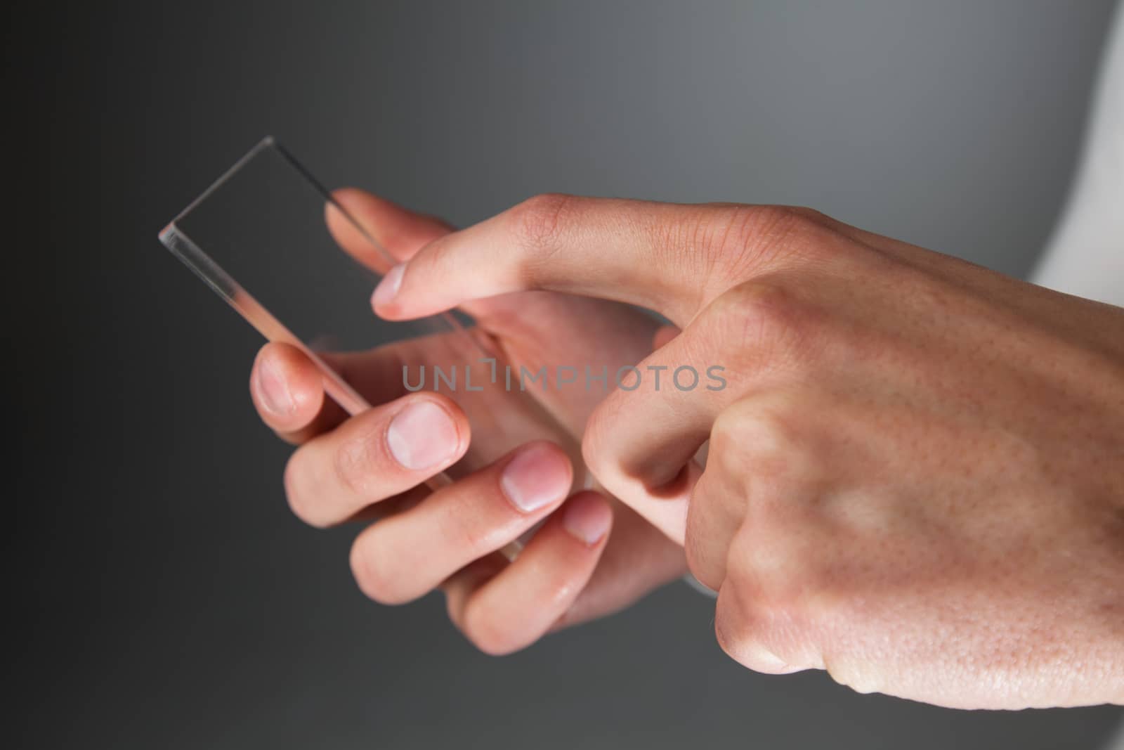 Hands holding futuristic transparent phone by ALotOfPeople