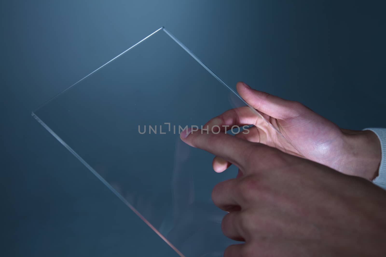 Hands holding futuristic transparent tablet pc by ALotOfPeople