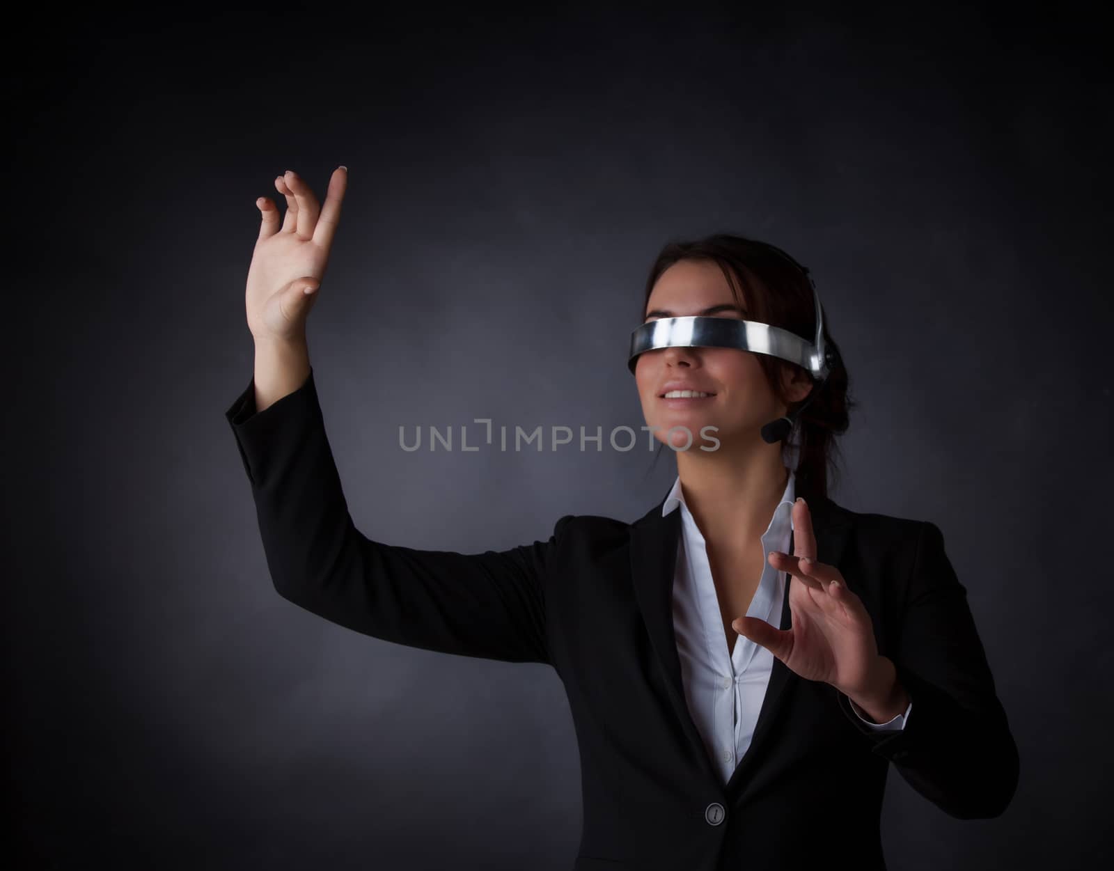 Business woman using futuristic VR goggles by ALotOfPeople